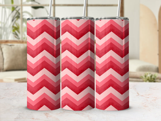 Pink and red chevron pattern insulated tumbler with straw.