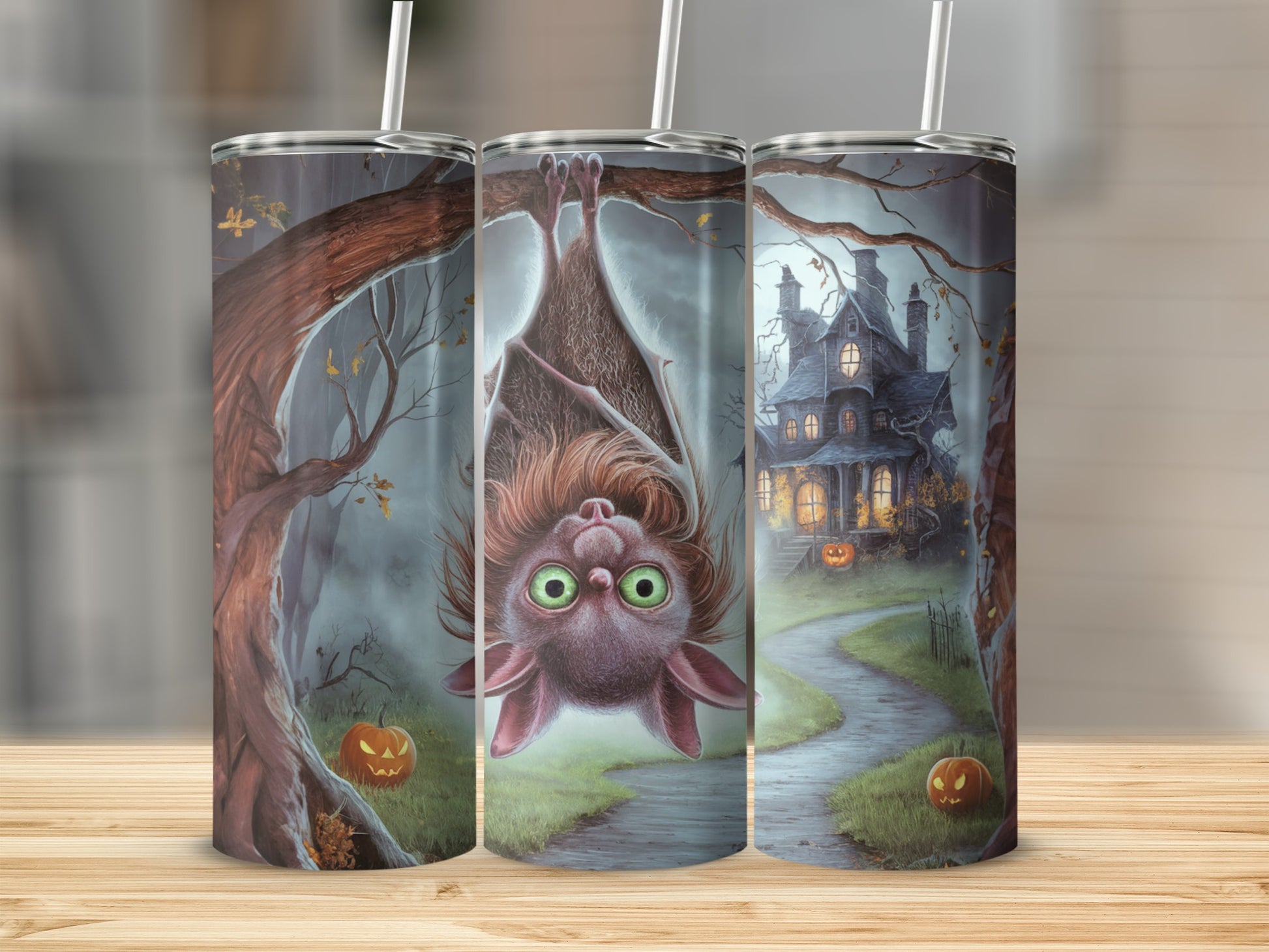 Halloween tumbler featuring a cute bat hanging upside down with a spooky house and pumpkins.