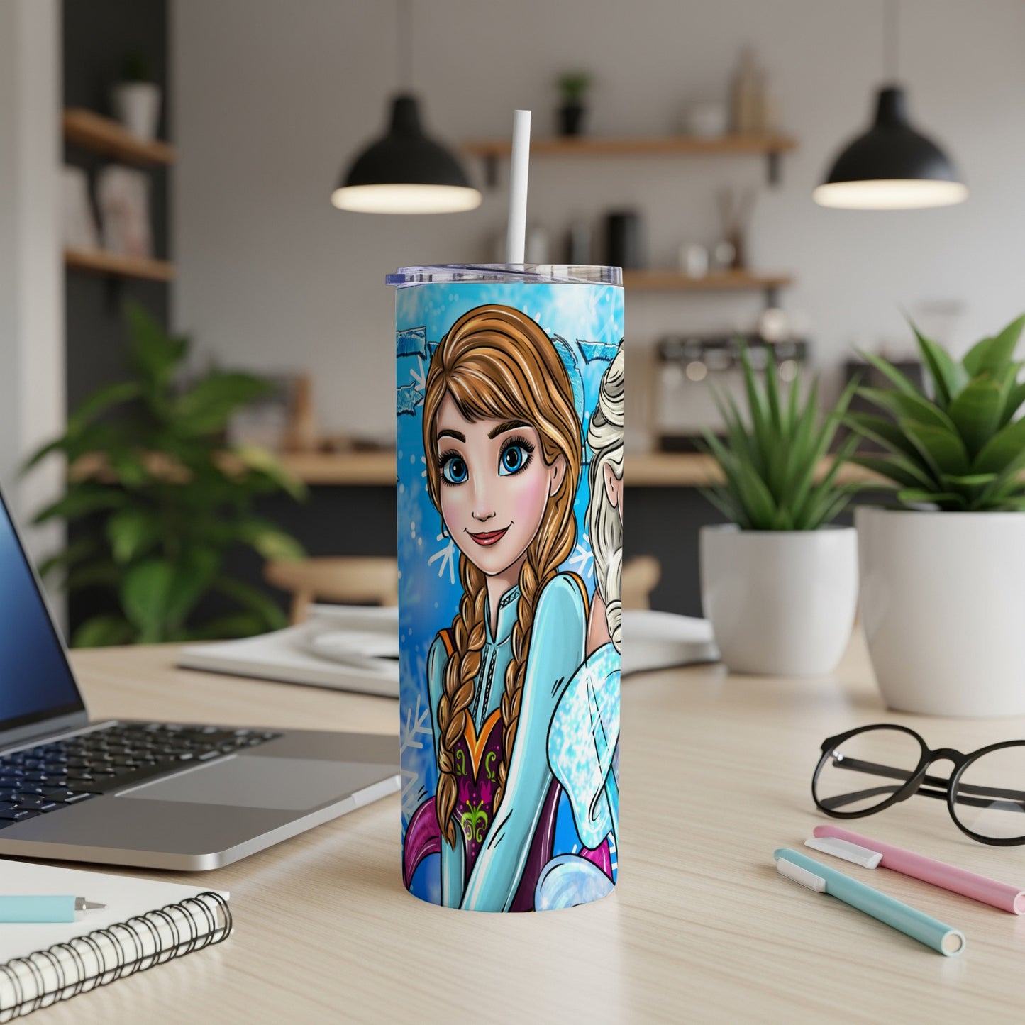 Elsa and Anna from Frozen on a blue patterned tumbler with straw.