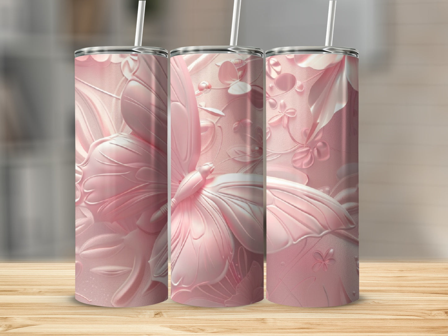 Three pink tumblers with embossed butterfly and floral designs.