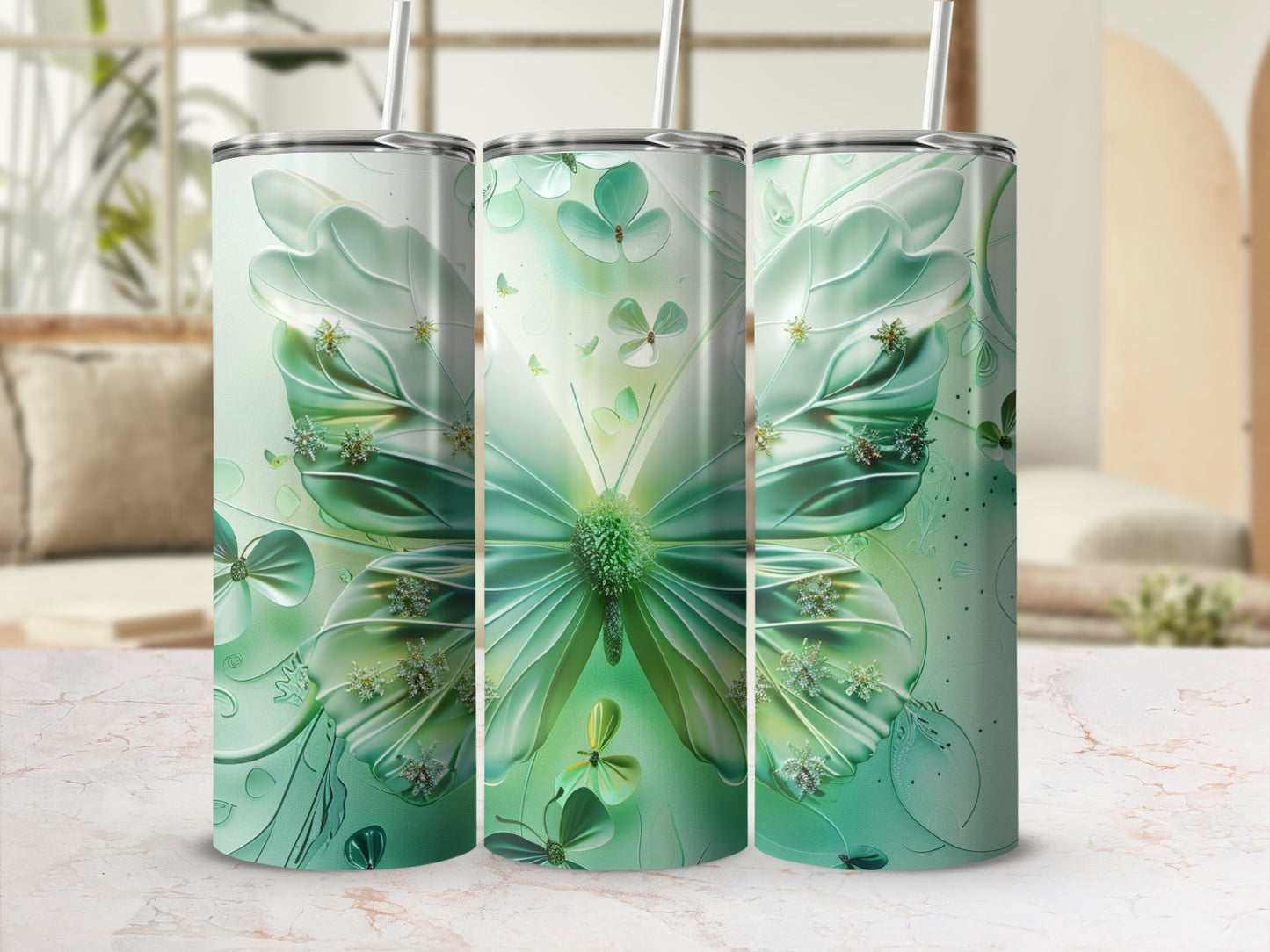 Green butterfly and clover design on three tumblers.