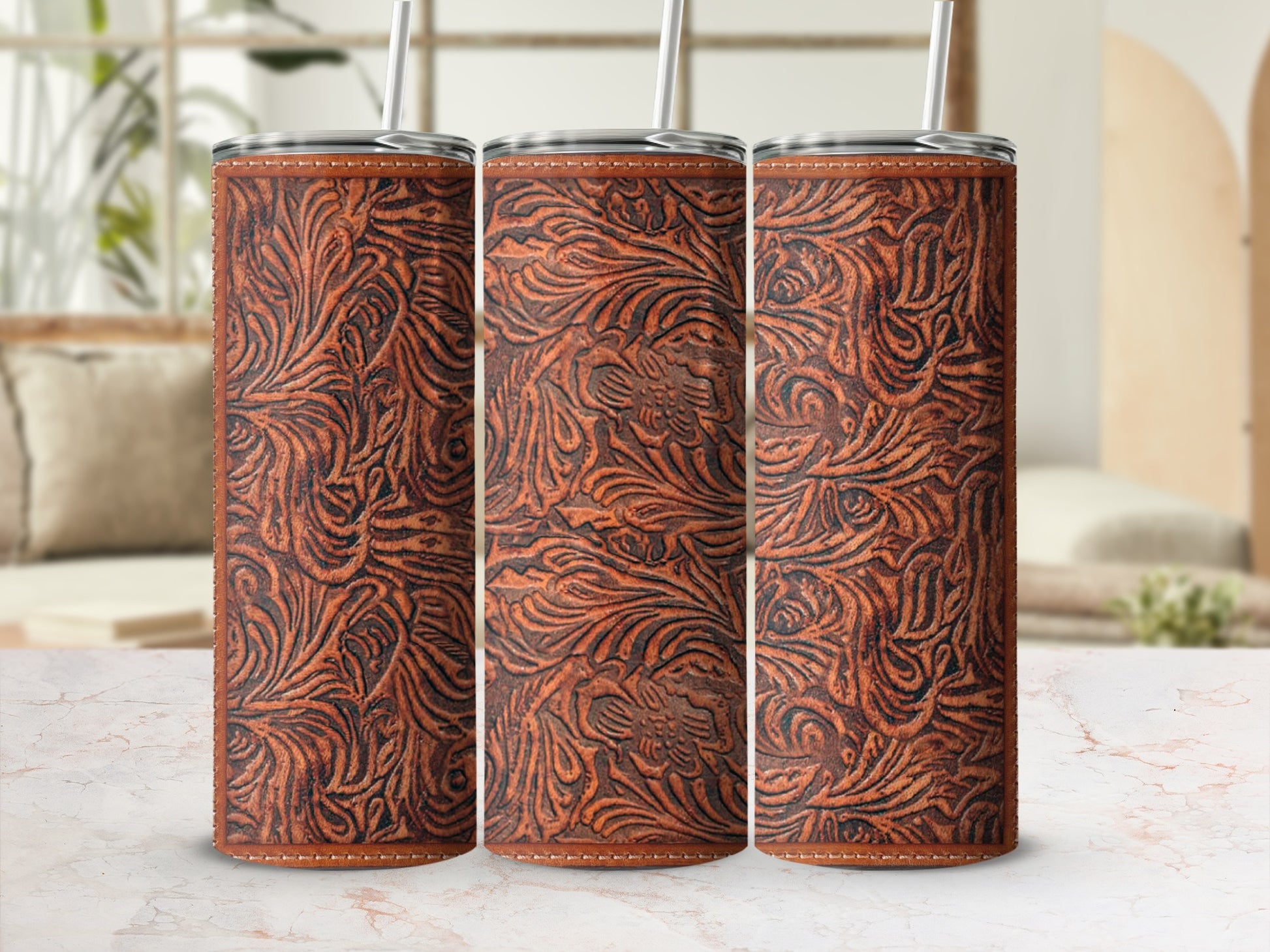 Three seamless faux leather patterned tumblers with straws.