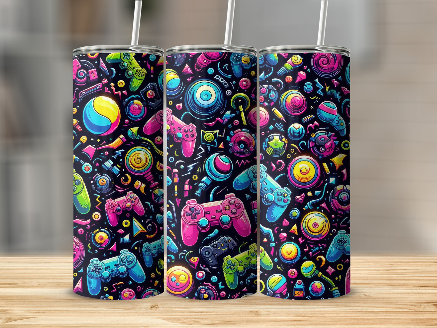Three tumblers with a colorful video game controller and icon pattern.