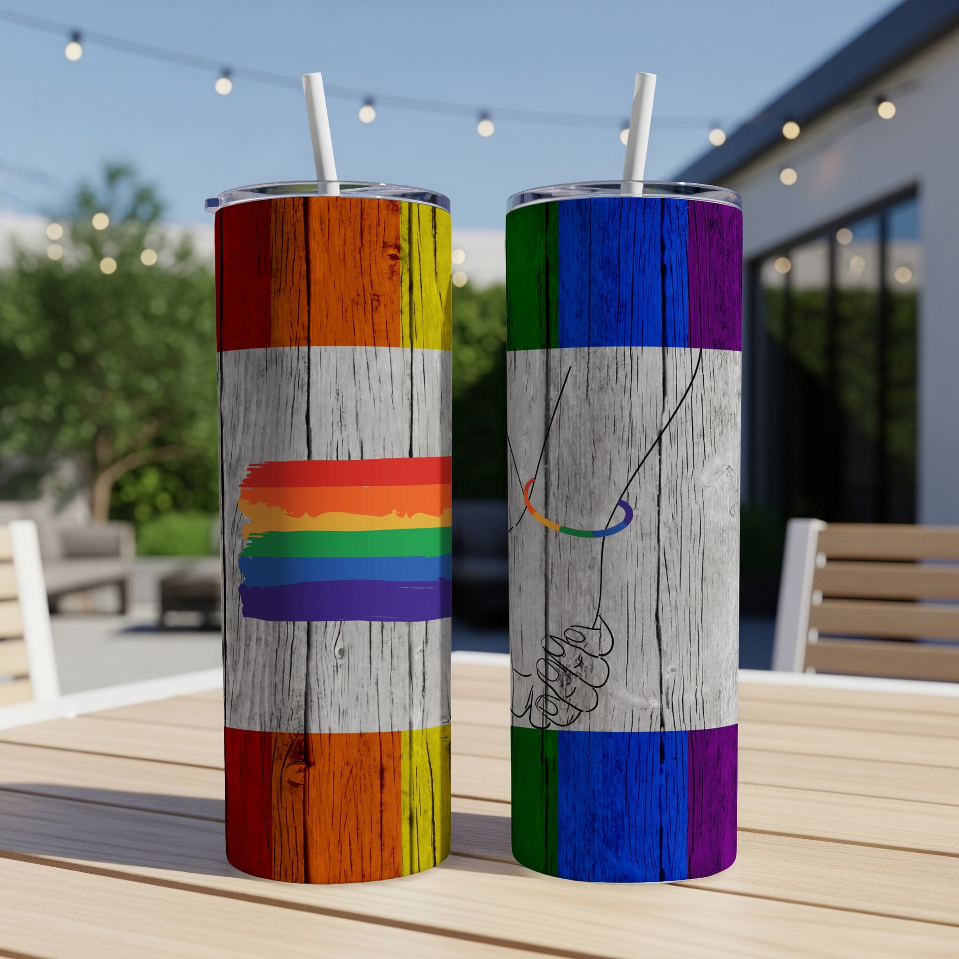 Two tumblers, one with rainbow stripes, the other with clasped hands.