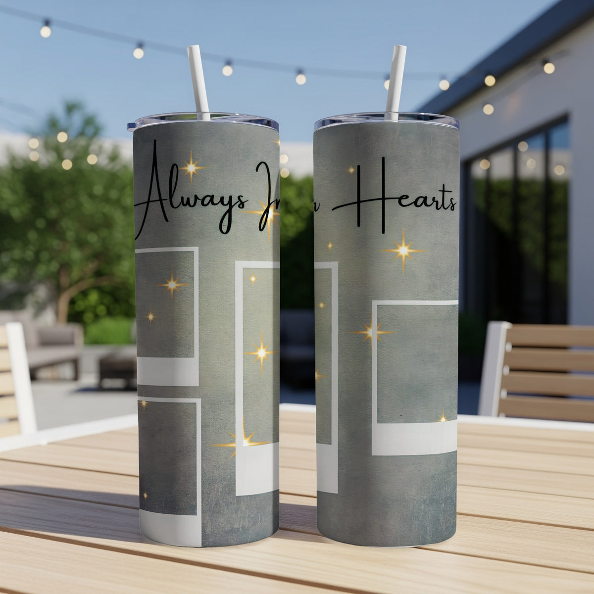 Two tumblers with "Always In Hearts" text and empty photo frames on a table.