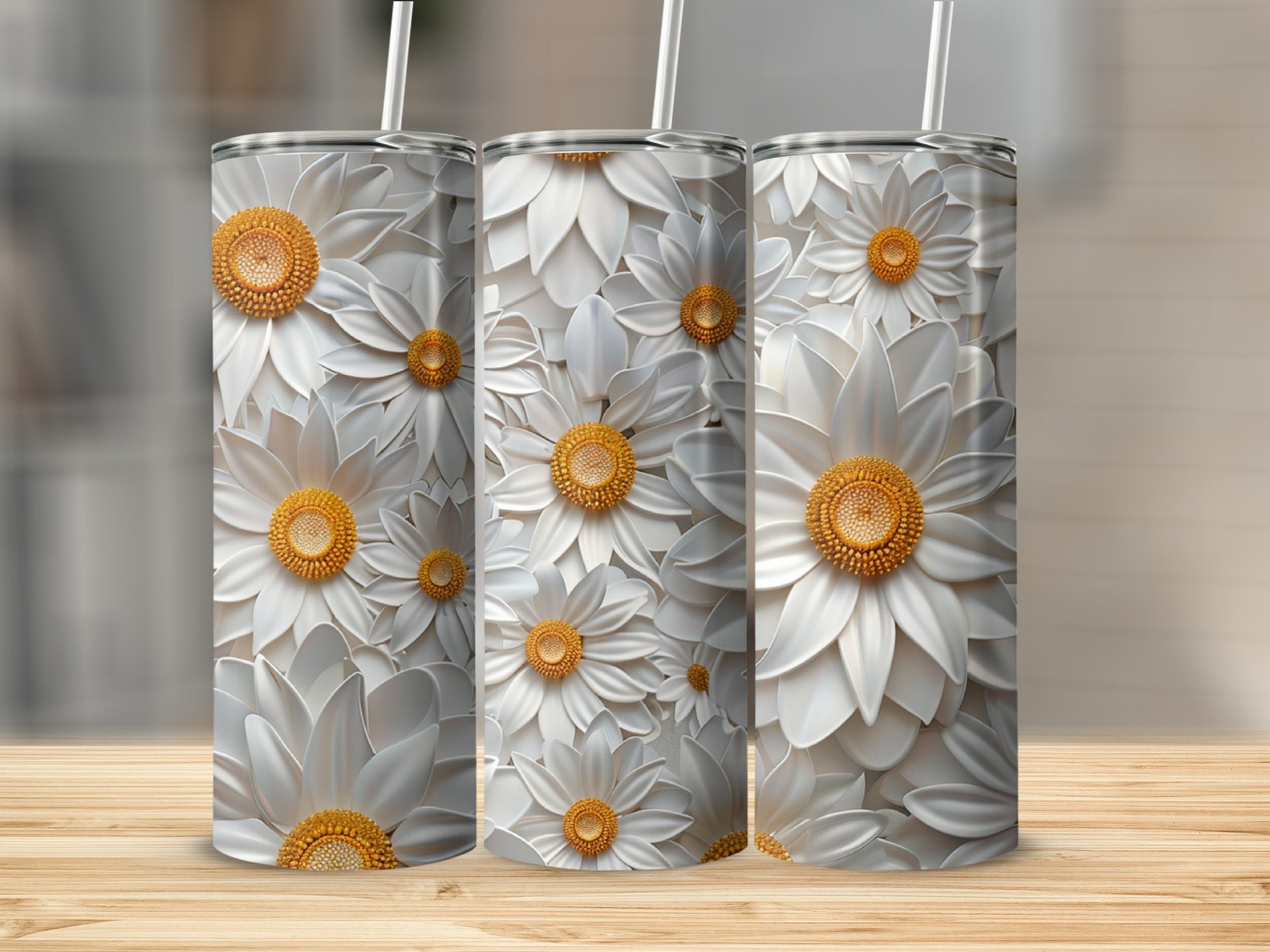 Three white daisy tumblers with straws on a wooden surface.