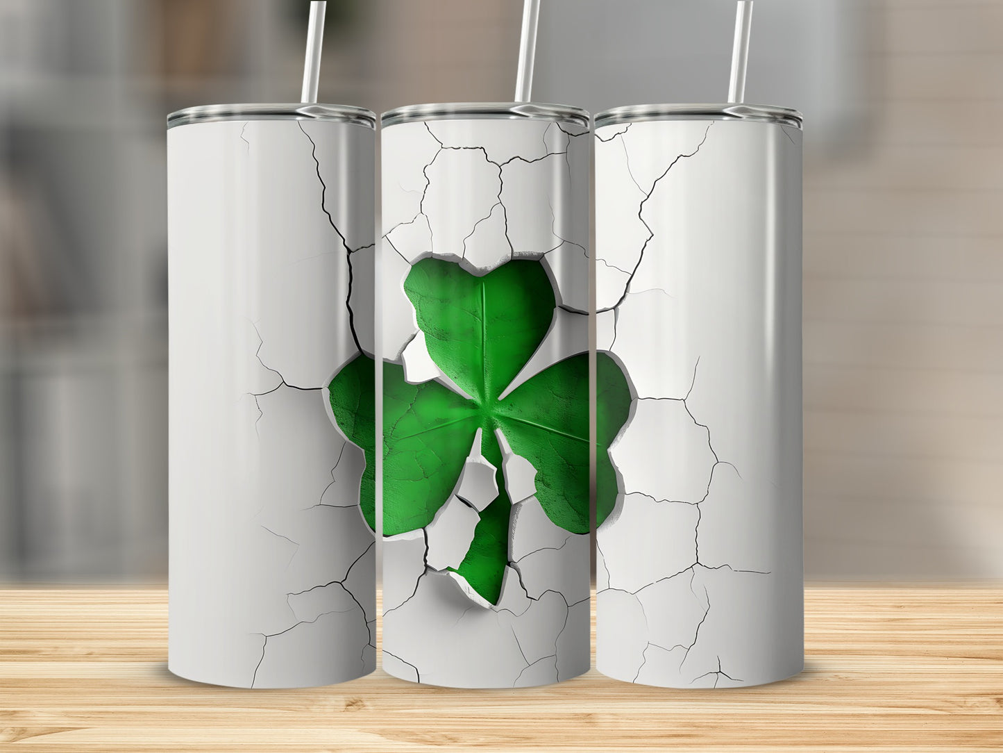 Three white tumblers with a cracked design revealing a green shamrock.