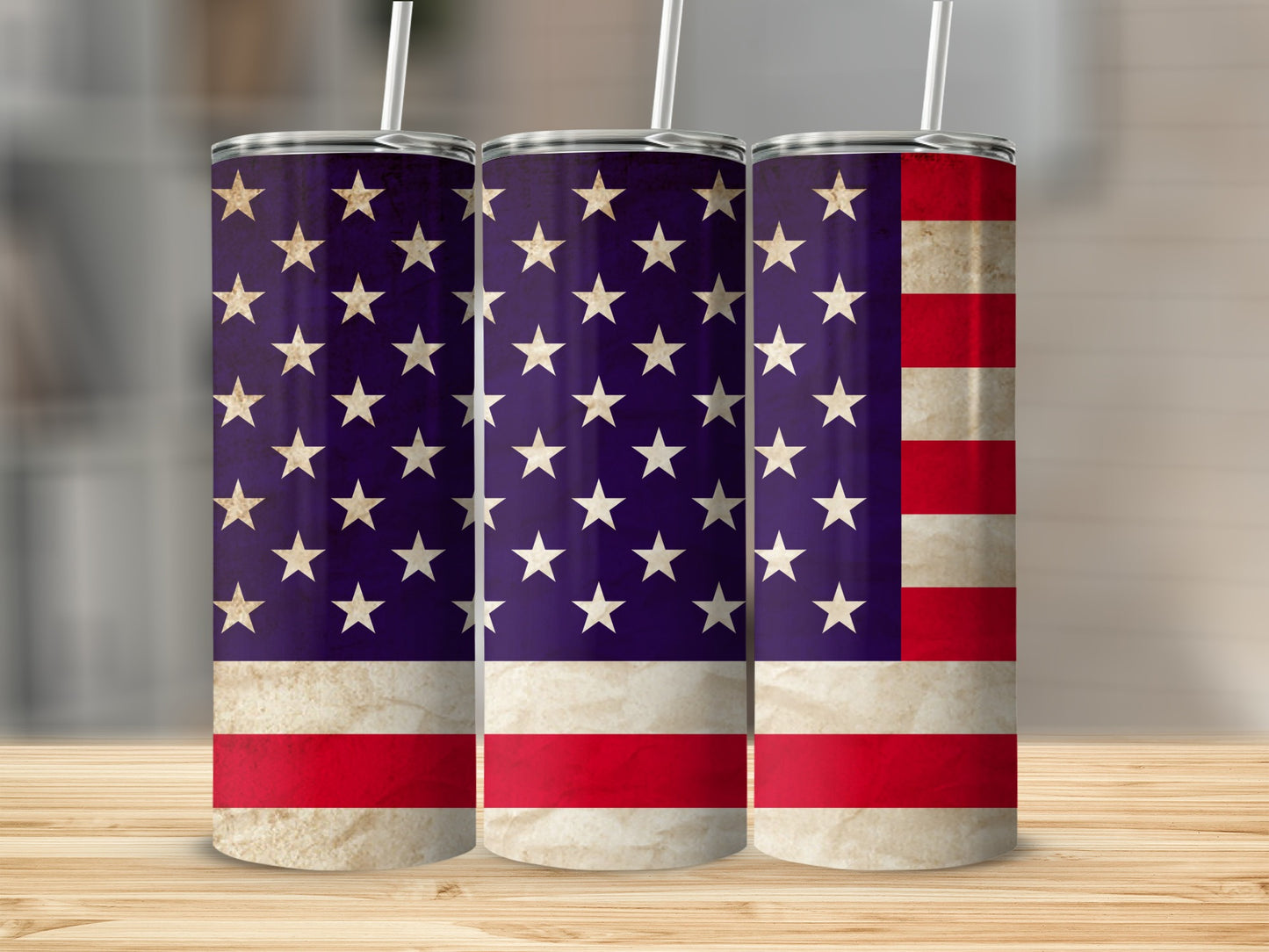 Three tumblers with American flag design on a wood surface.