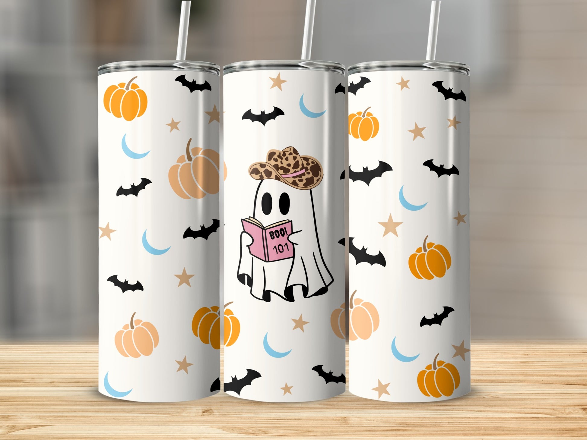 White tumblers with Halloween pattern: ghost, pumpkins, bats, moons, and stars.