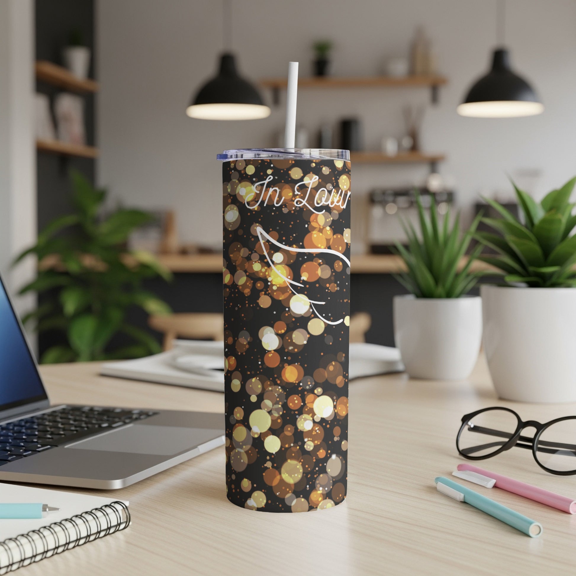 Black tumbler with gold bokeh sparkle design and "In Love" text.