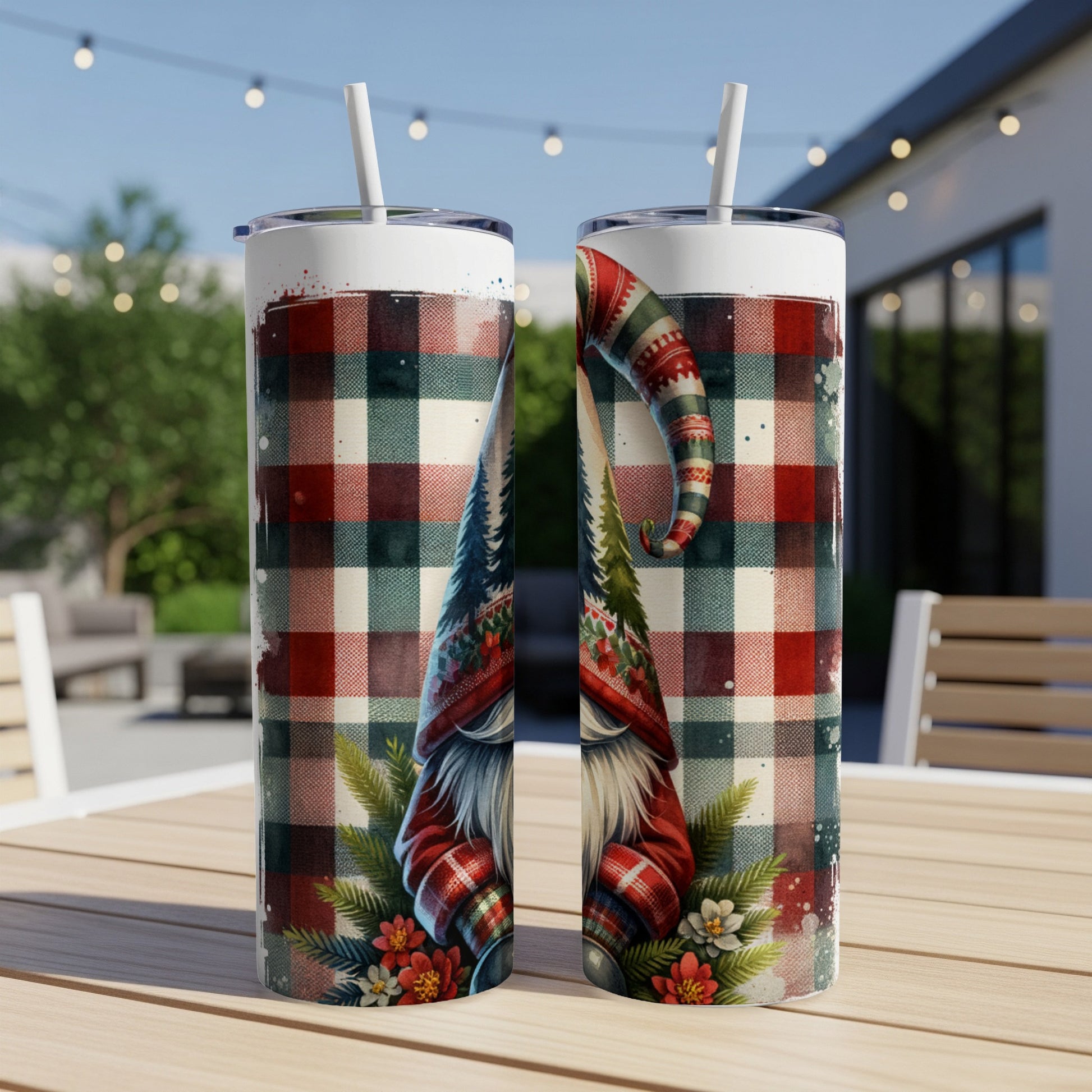 Two Christmas gnomes with plaid hats stand on a wooden table.