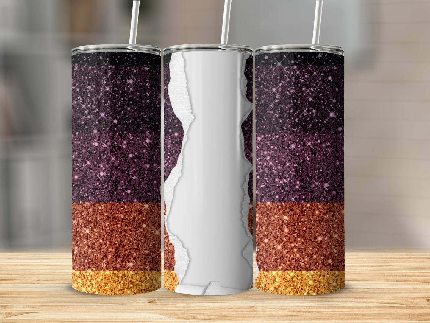 Three tumblers with glittery purple and orange designs on a wooden surface.