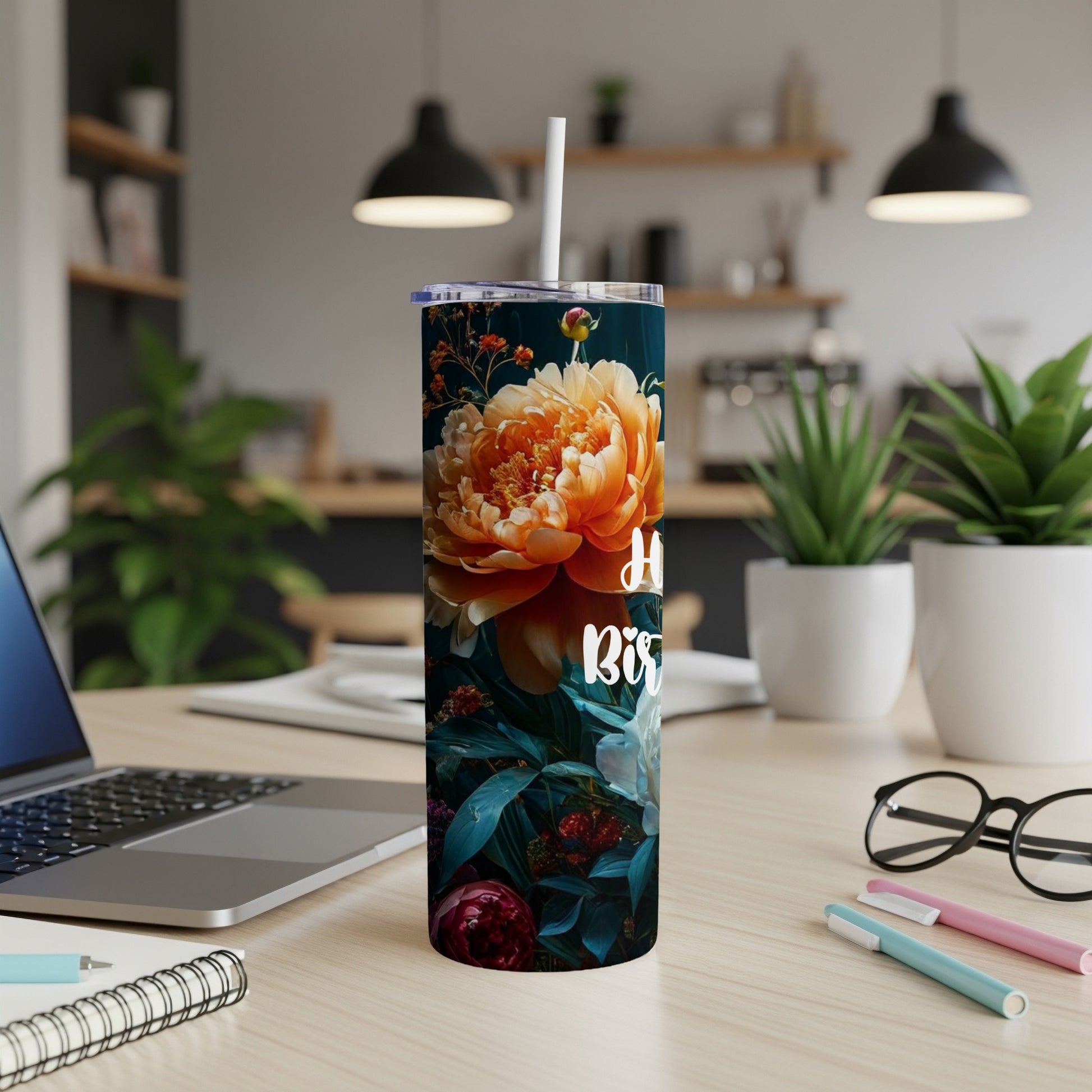 Tall floral tumbler with "Happy Birthday" text on wooden desk.