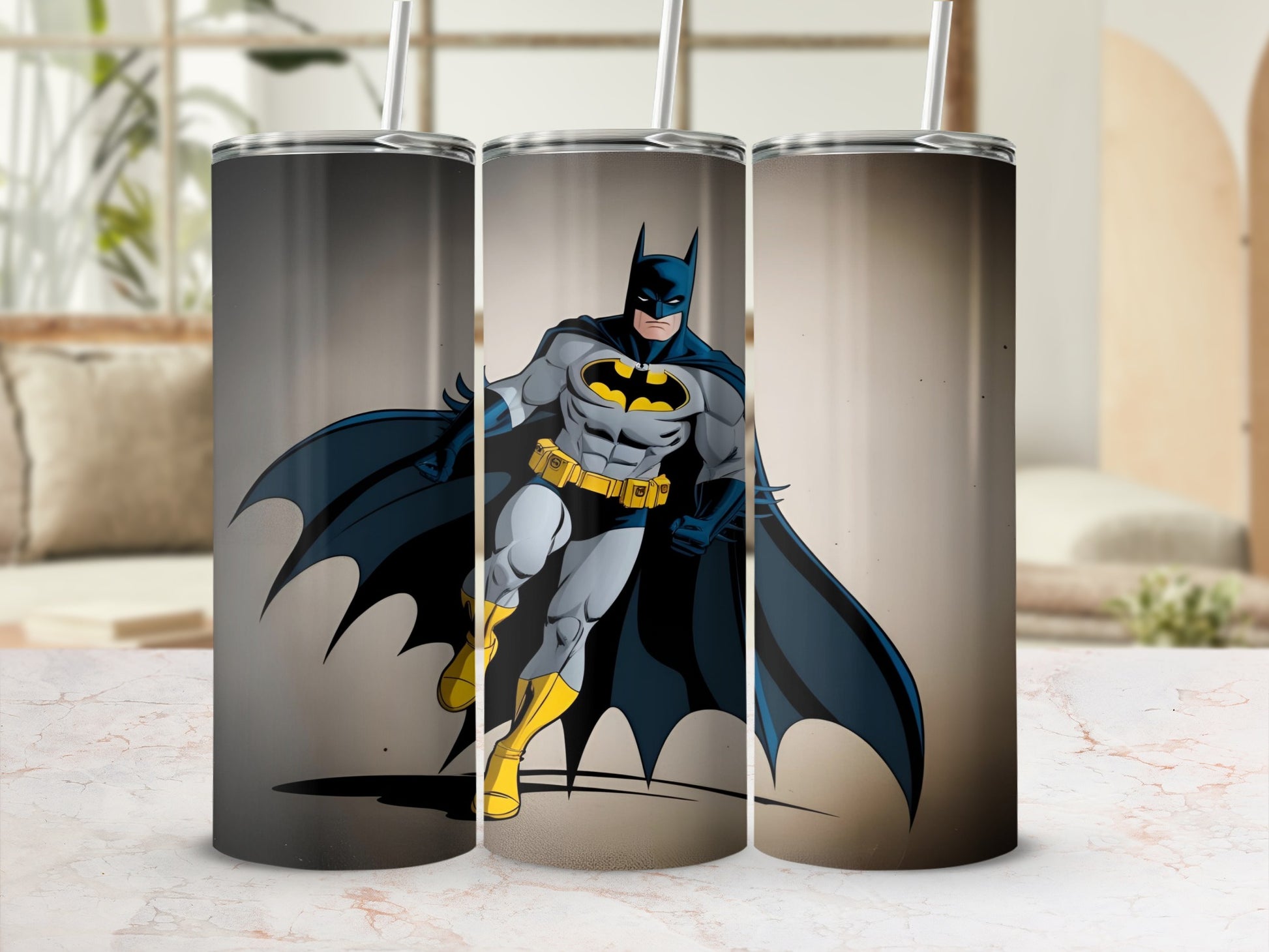 Batman superhero illustration on three tumblers against a blurred background.