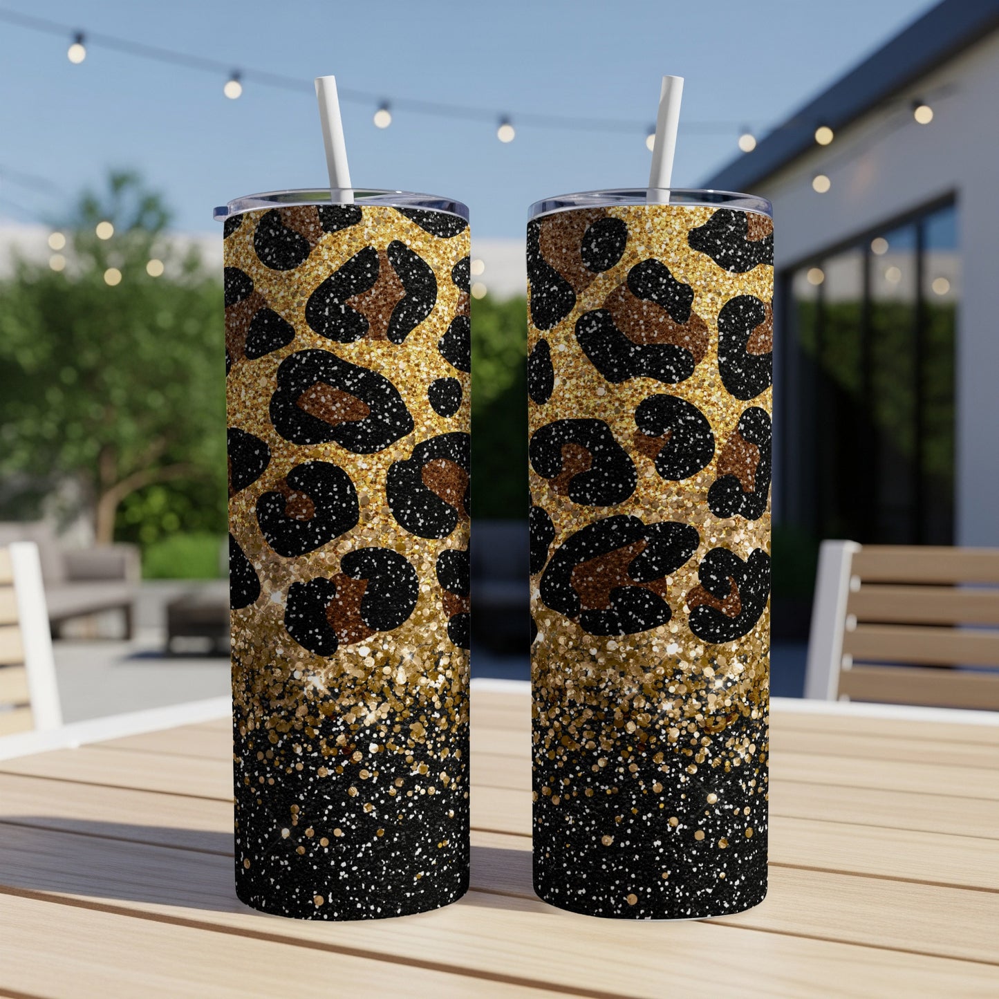 Two tall tumblers with leopard print and glitter designs sit on a table.