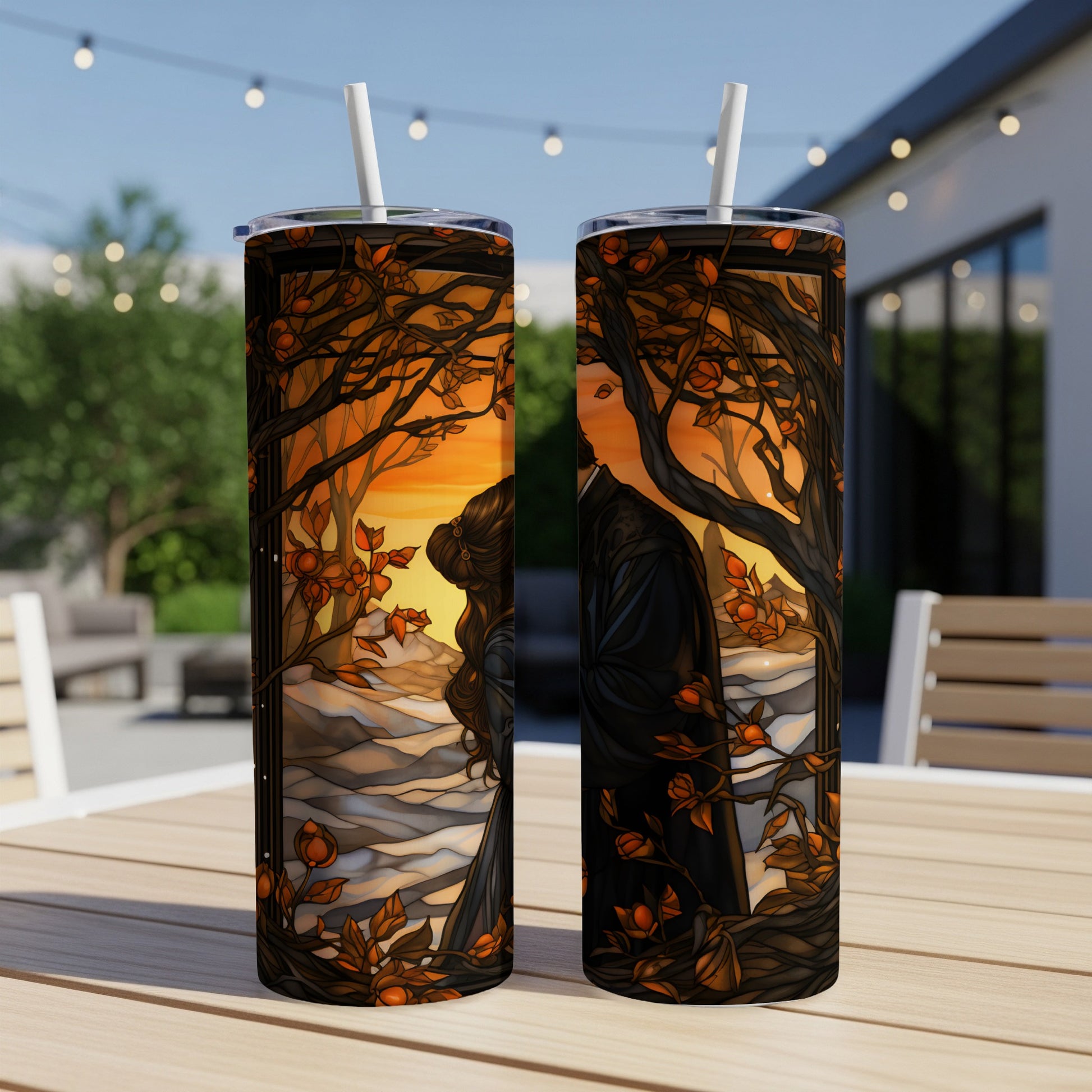 Couple embracing amidst autumn trees at sunset, artwork on two tumblers.