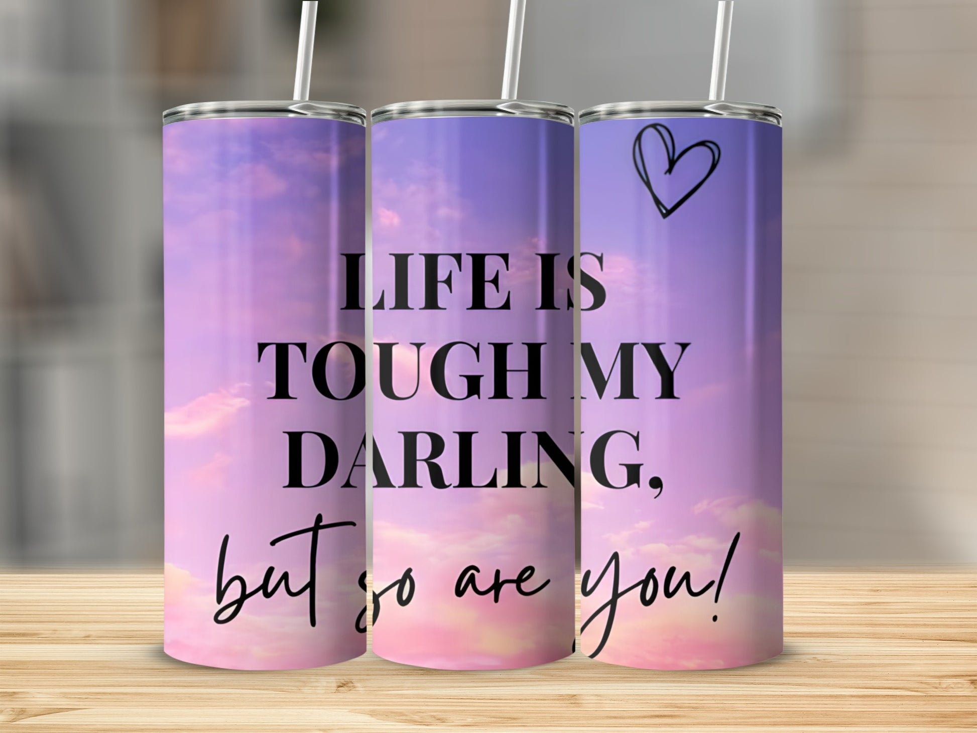Purple and pink sky tumbler with quote "Life is tough my darling, but so are you!".