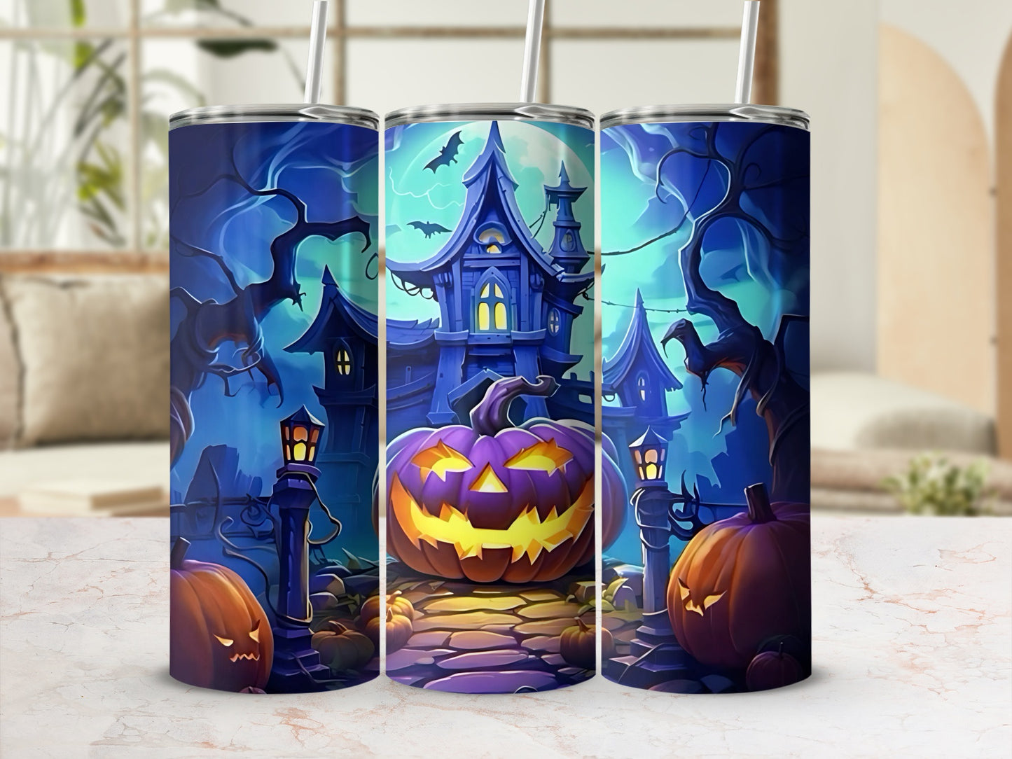 Three tumblers decorated with a spooky Halloween scene of a haunted house and pumpkins.