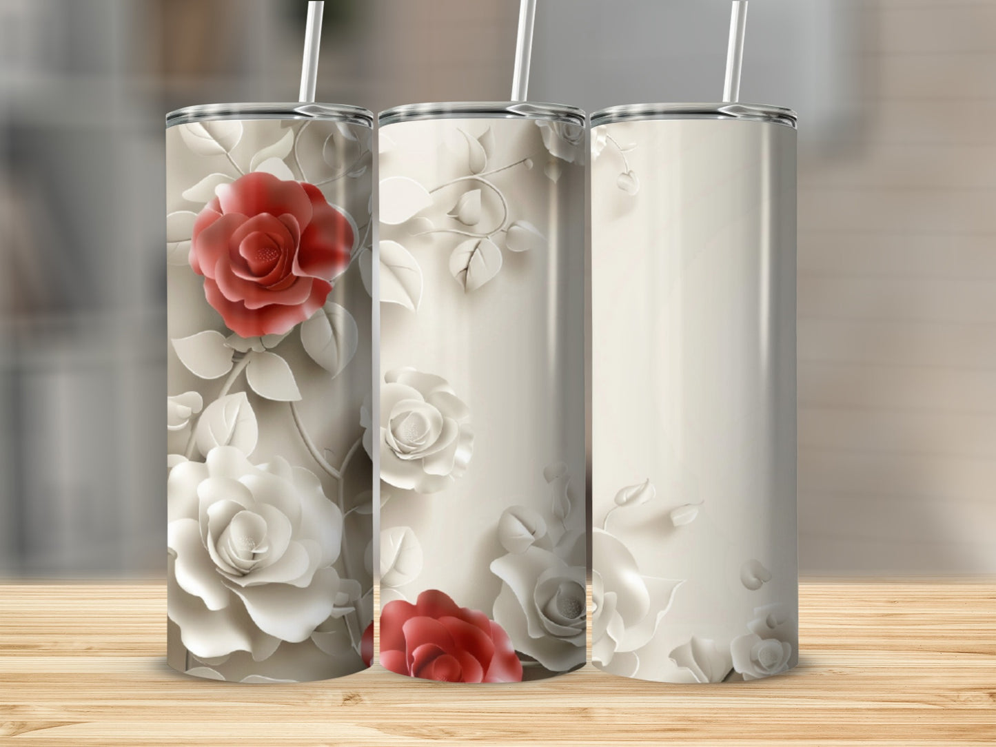 Three tall, skinny tumblers featuring embossed cream and red roses.