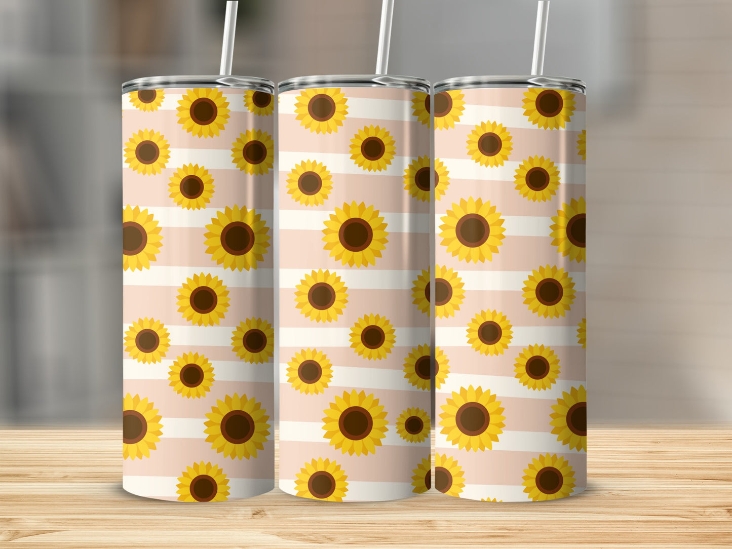 Three tumblers with a repeating pattern of sunflowers on a light pink and white striped background.