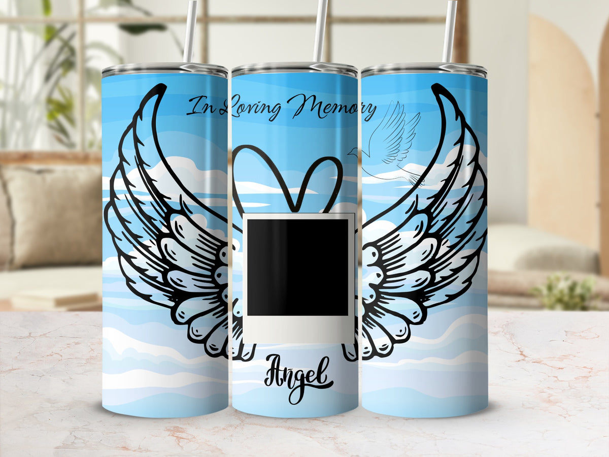 Tumbler with "In Loving Memory" text, wings, dove, and "Angel" text on blue sky background.