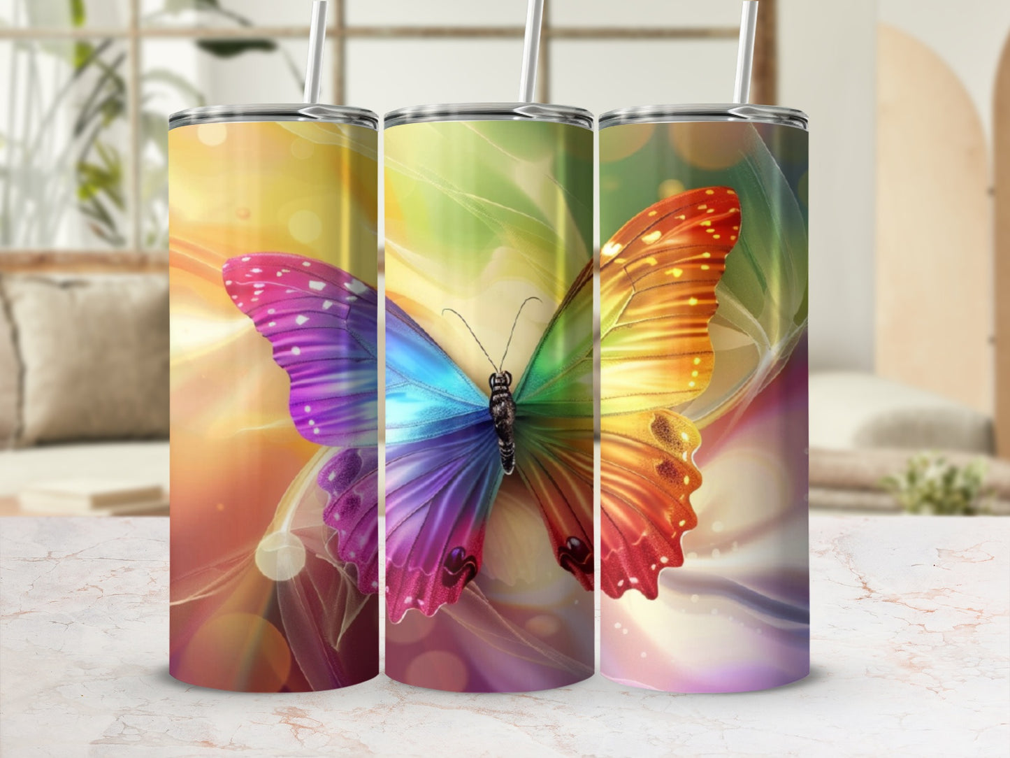 Three tumblers displaying a colorful butterfly against a blurred, bright background.