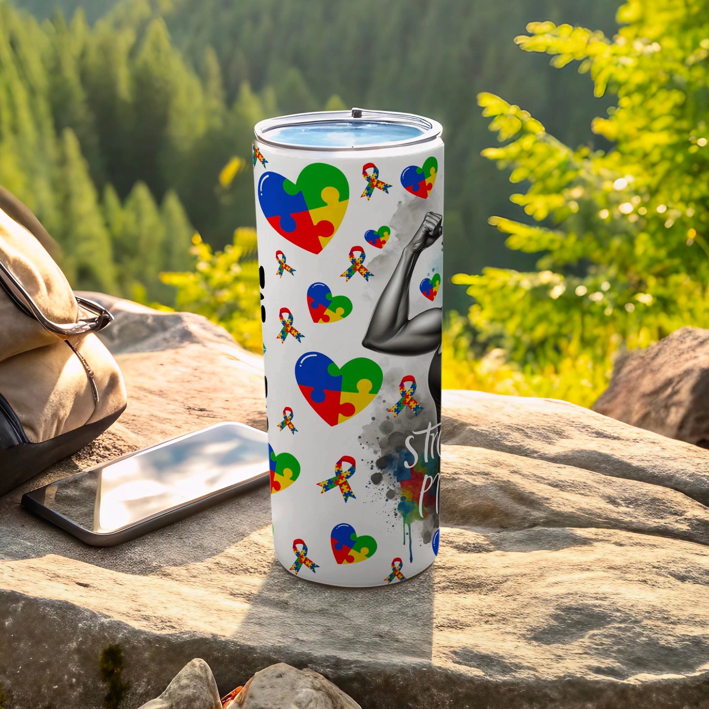 White tumbler with puzzle pieces, arm muscles, and watercolor splatters.