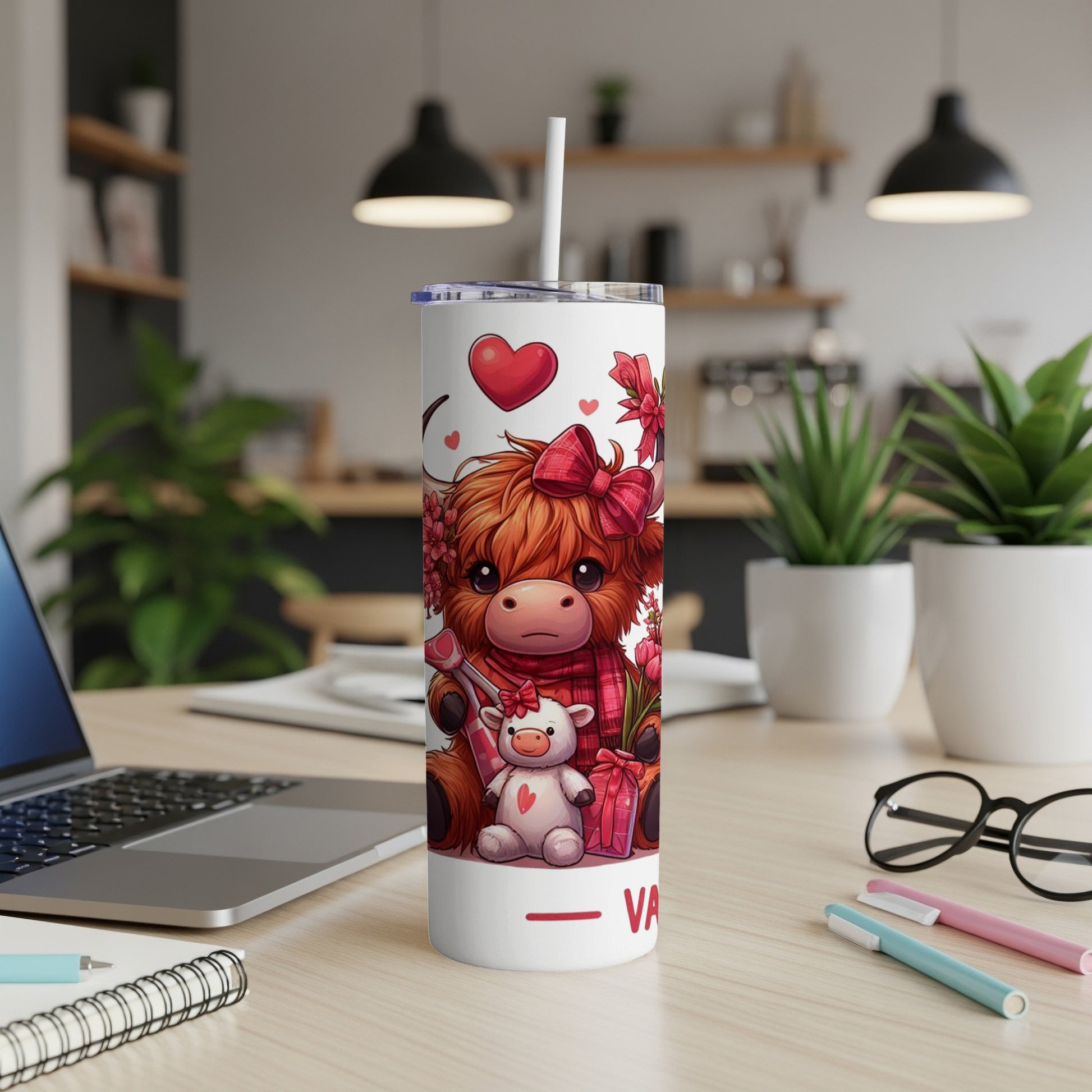 White tumbler with cute cartoon Highland cow and teddy bear design.