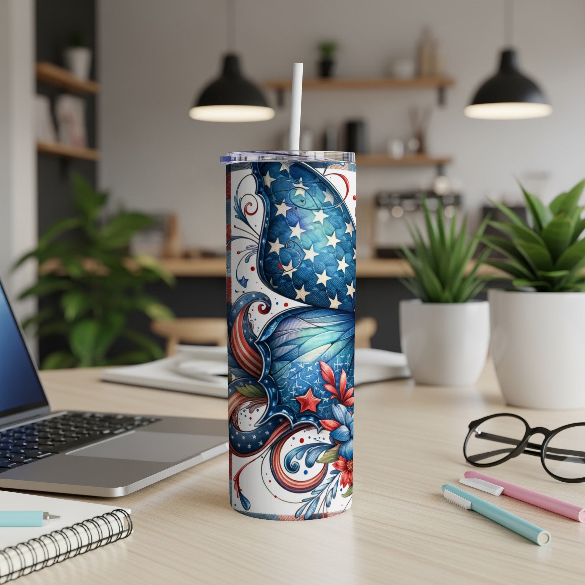 Stars and stripes tumbler with a straw on a desk.