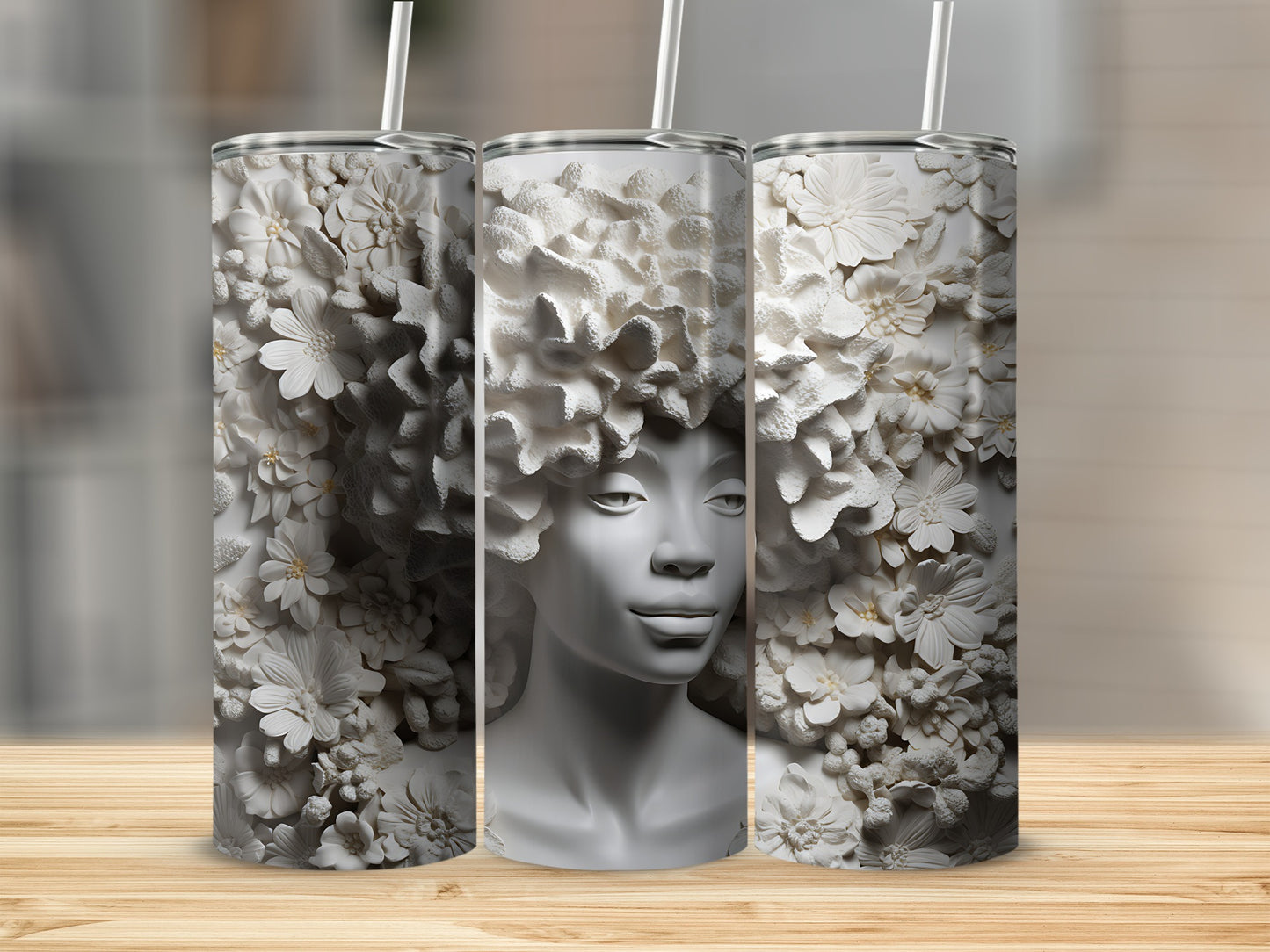 Three white tumblers with raised floral patterns and a woman's face.