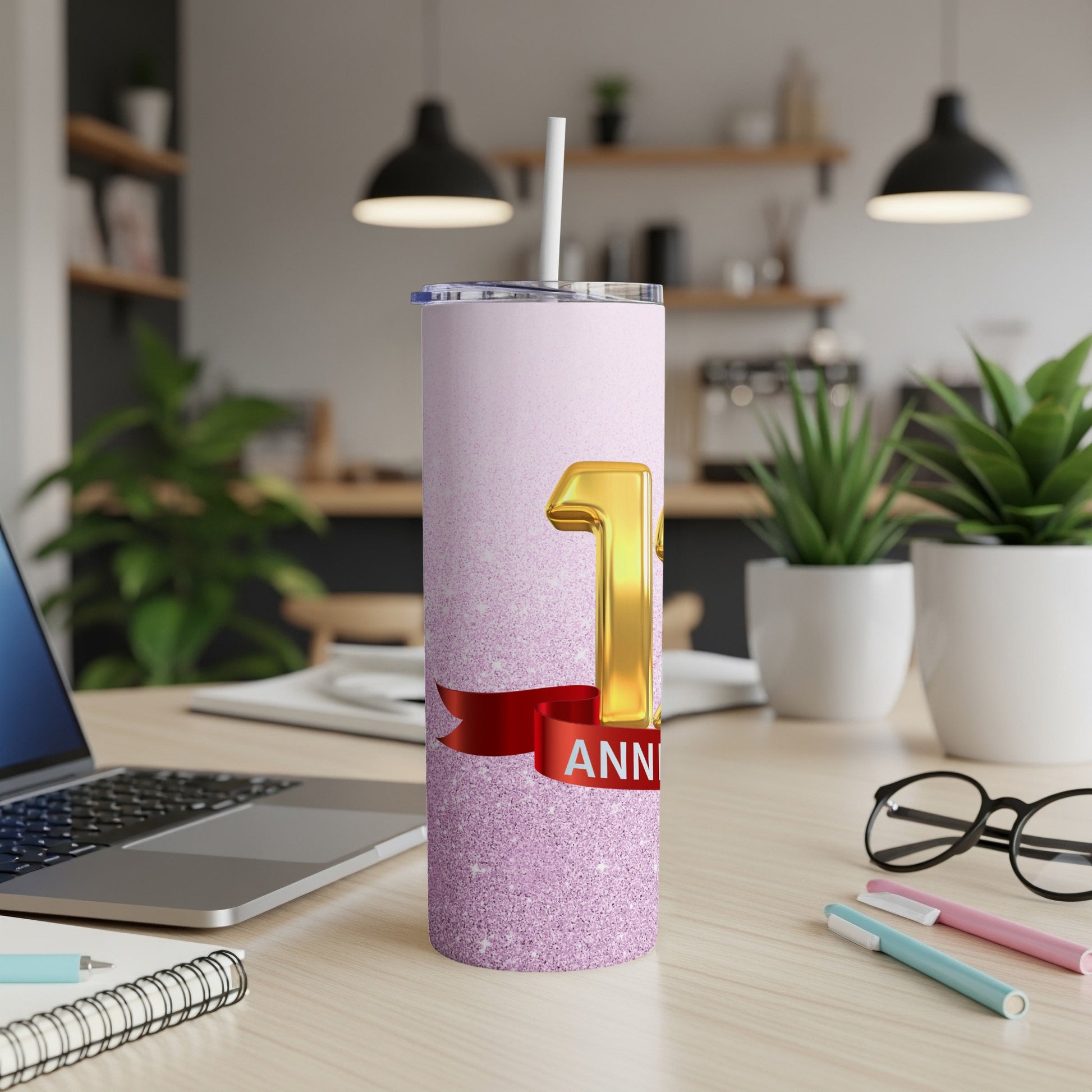 Pink glitter tumbler with "1 ANNIVERSARY" text and red ribbon.