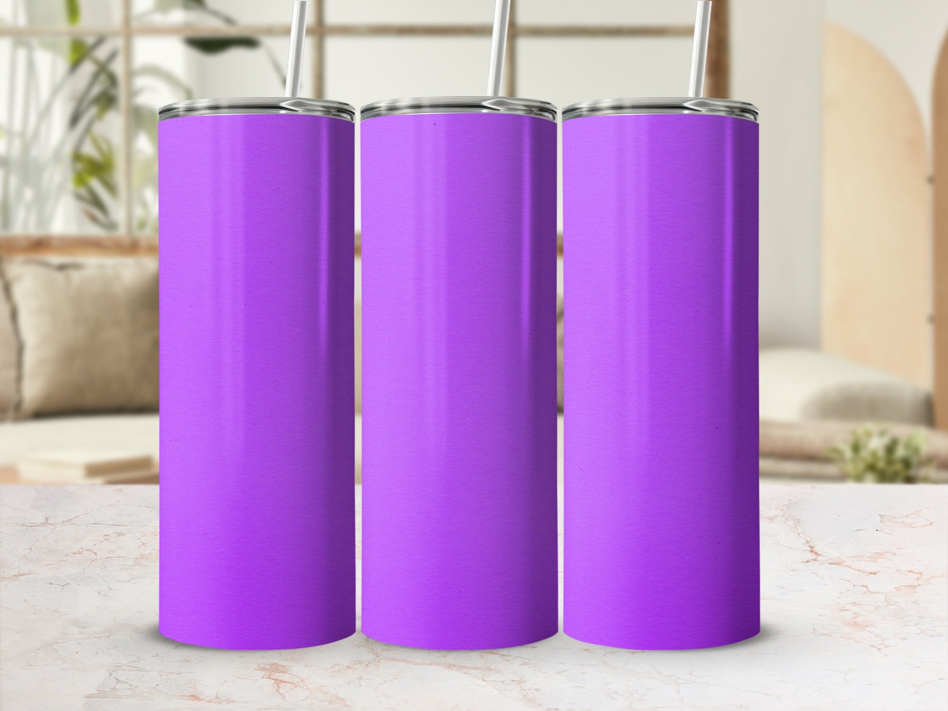 Three plain purple tumblers with straws on a marble surface.