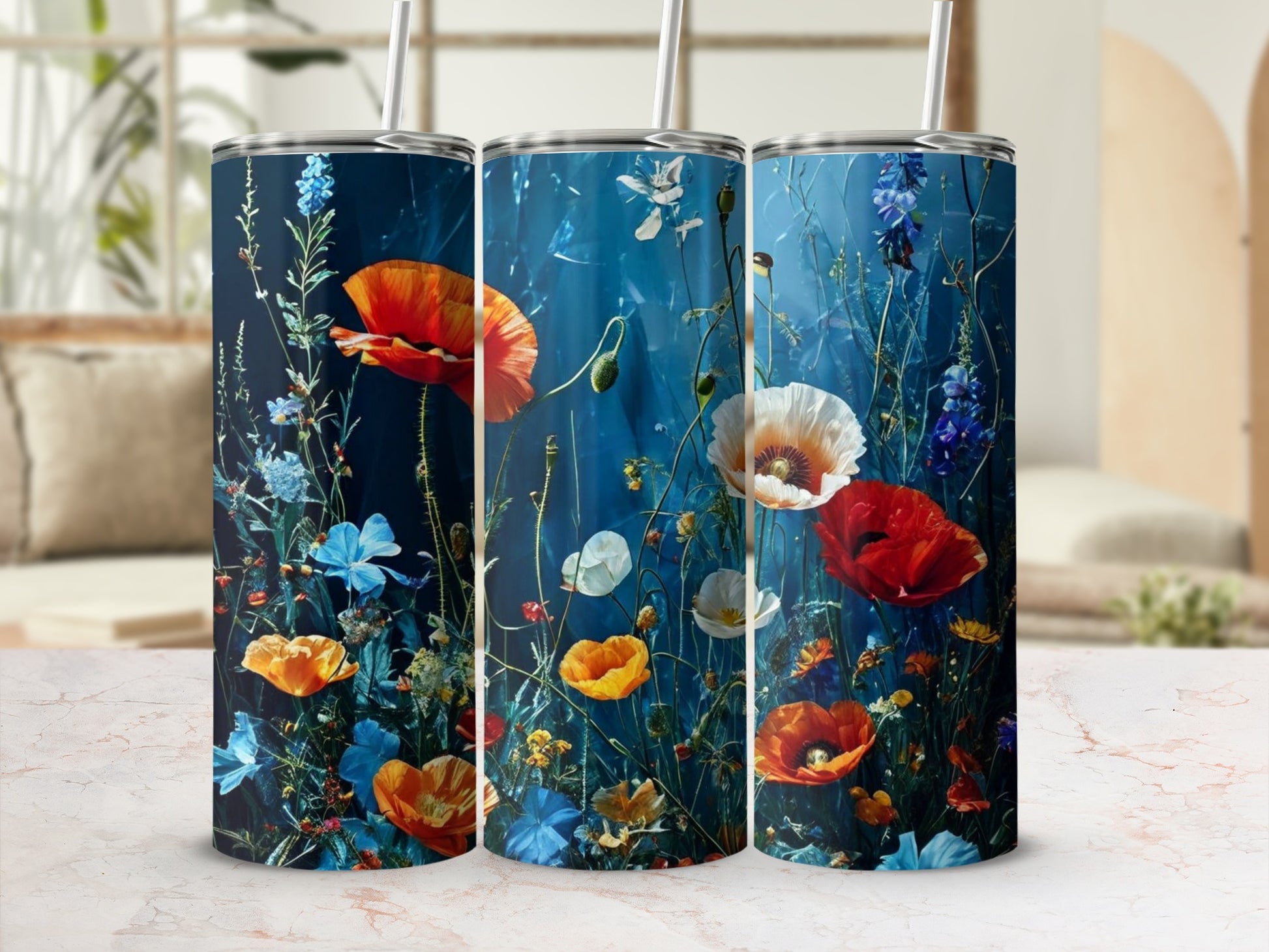 Blue tumbler with red and orange poppies, white and blue wildflowers, and greenery.