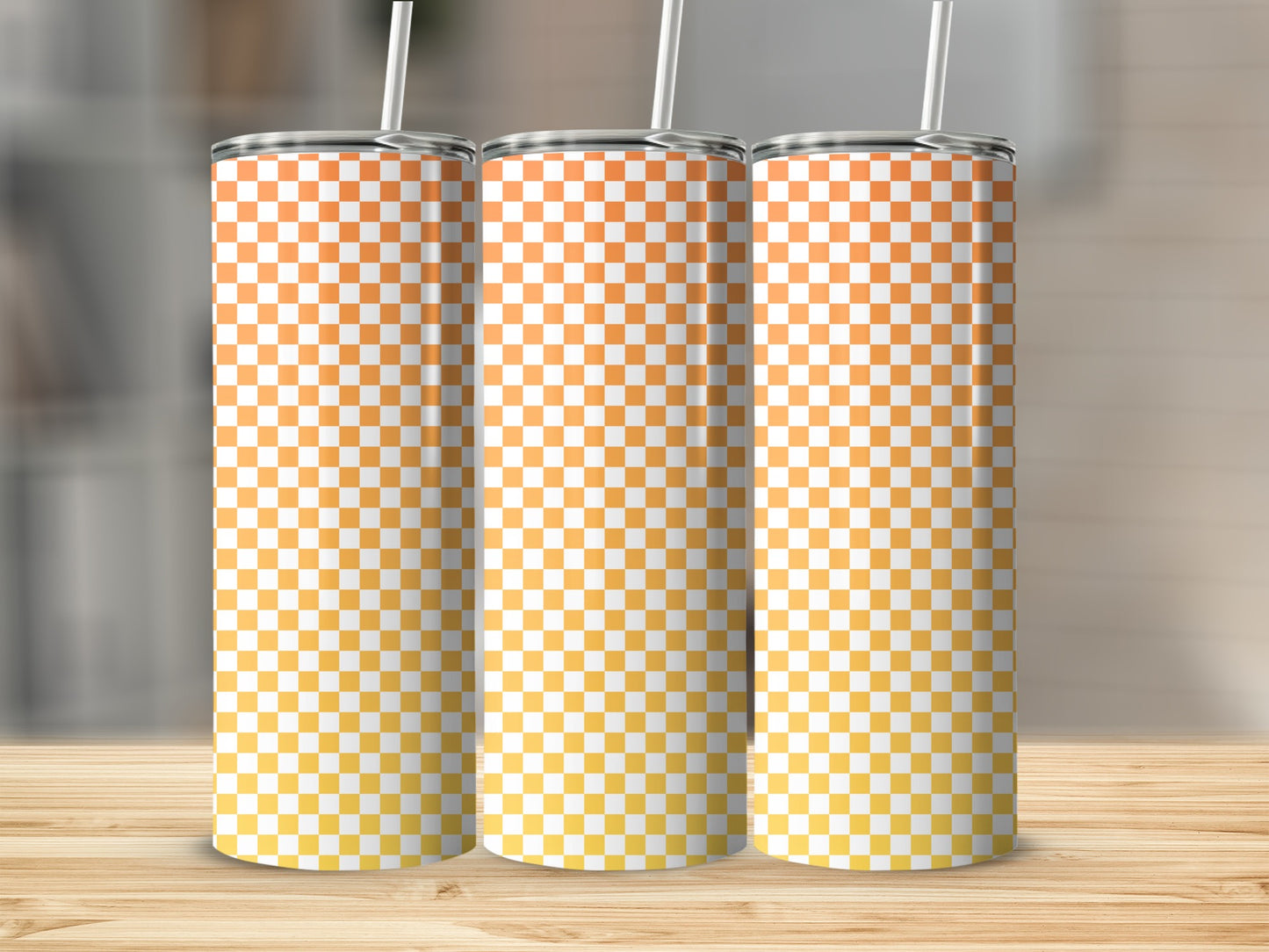 Three tumblers with orange and yellow checkered pattern and straws.