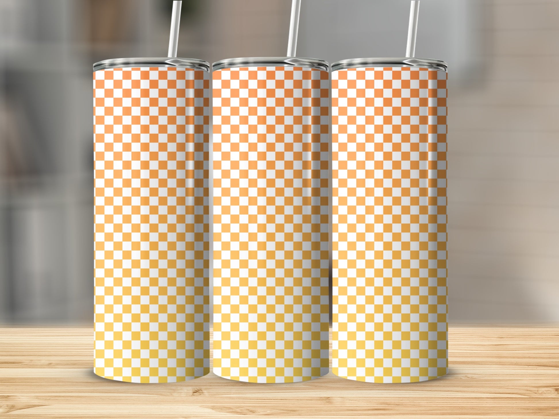 Three tumblers with orange and yellow checkered pattern and straws.