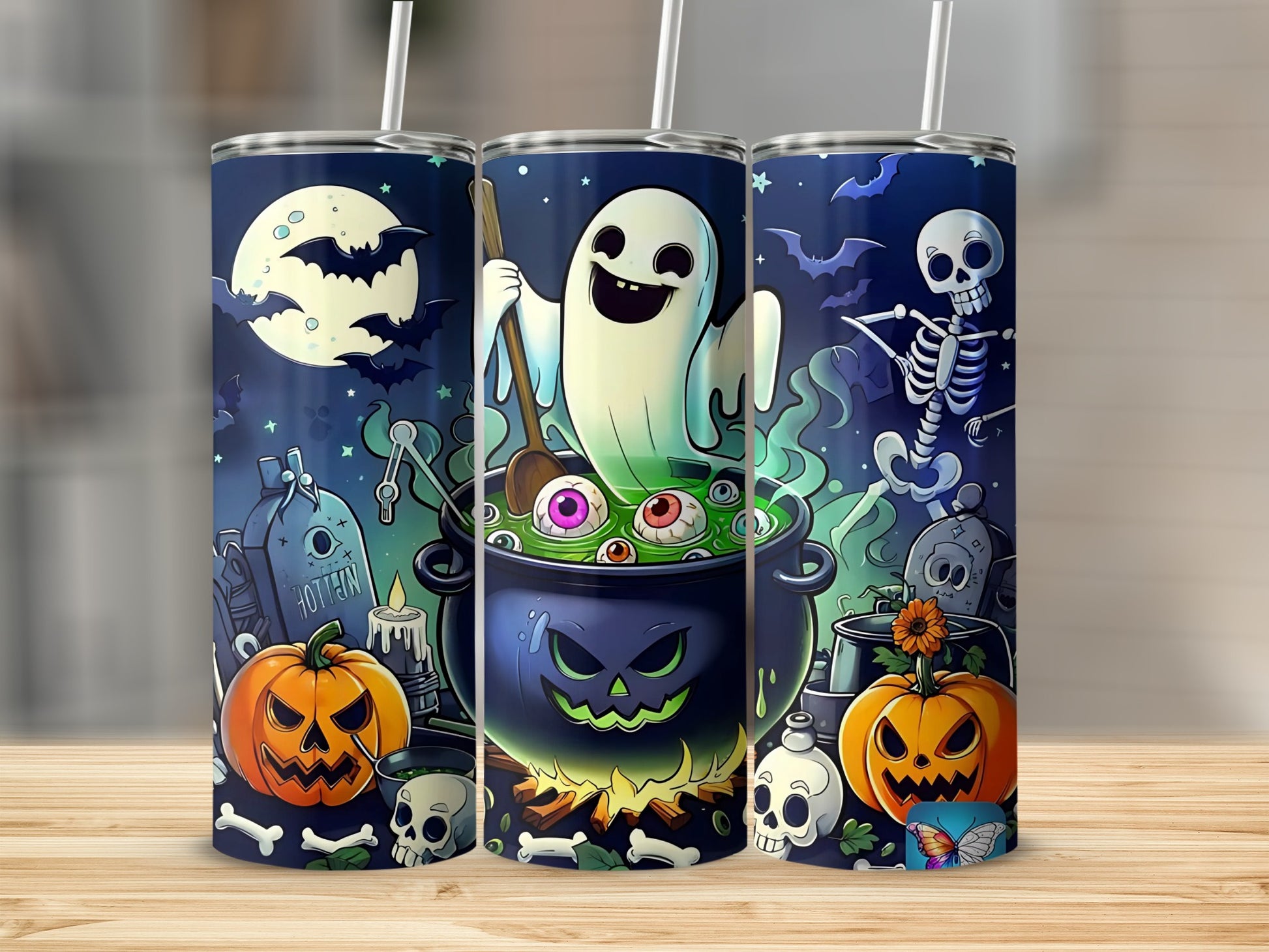 Three tumblers with Halloween designs featuring a ghost, skeleton, pumpkins, and spooky elements.