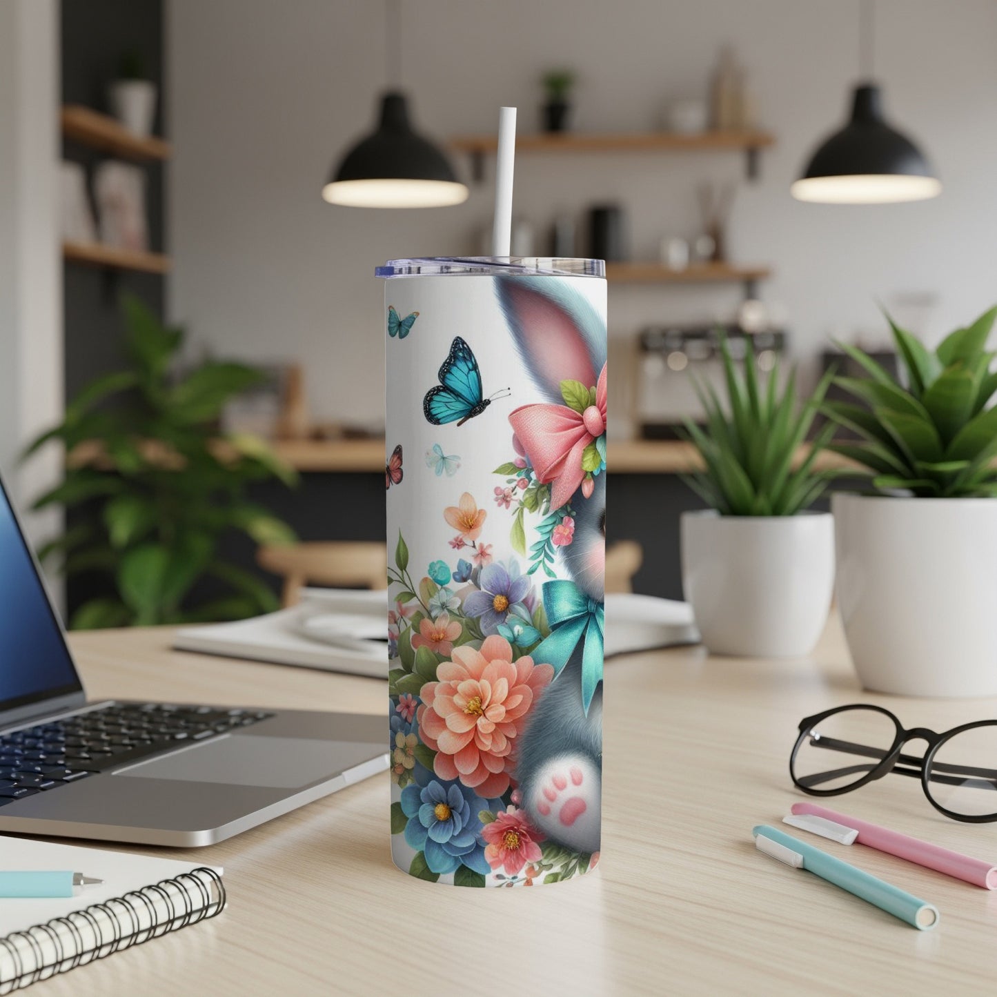 White tumbler with a bunny, butterflies, and floral design.