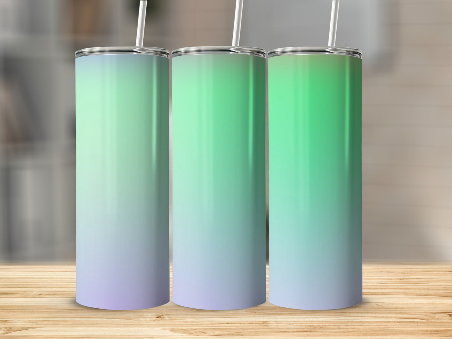 Three stainless steel tumblers with straw and a gradient of green to purple.