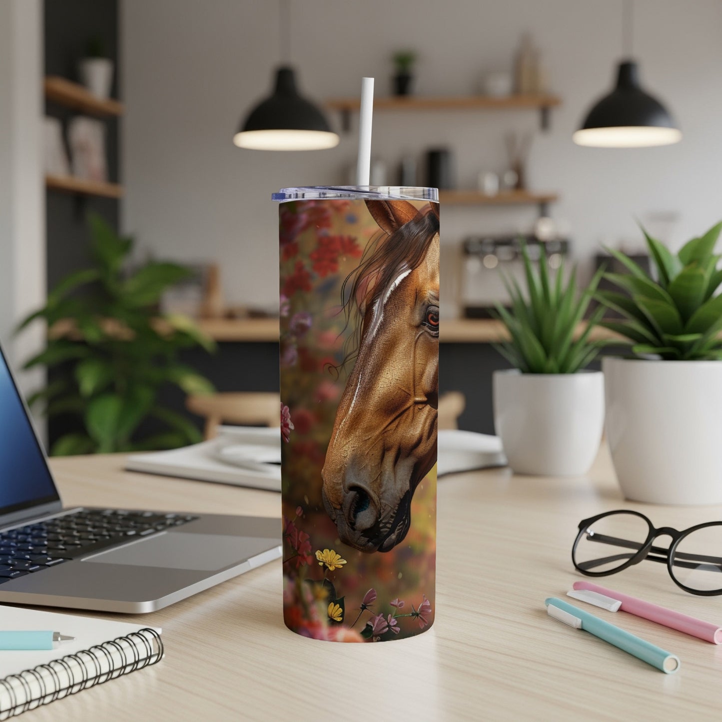 Horse tumbler with floral pattern on desk with laptop.