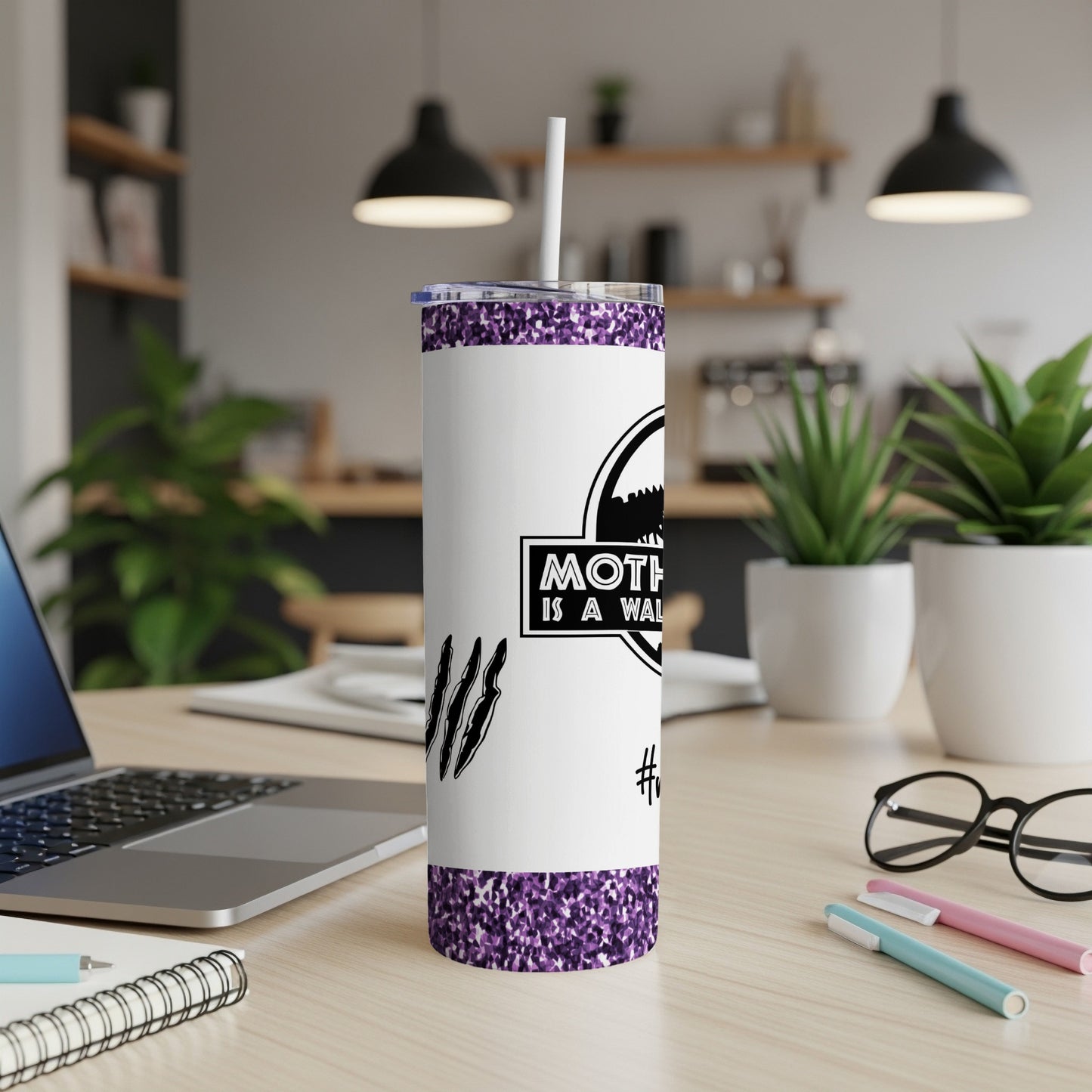 White tumbler with "Mother is a walking miracle" text and claw marks.