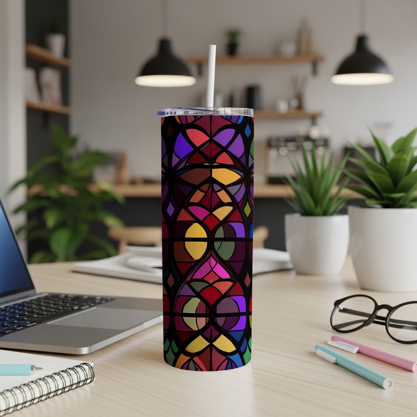 Stained glass pattern tumbler with straw on a desk.