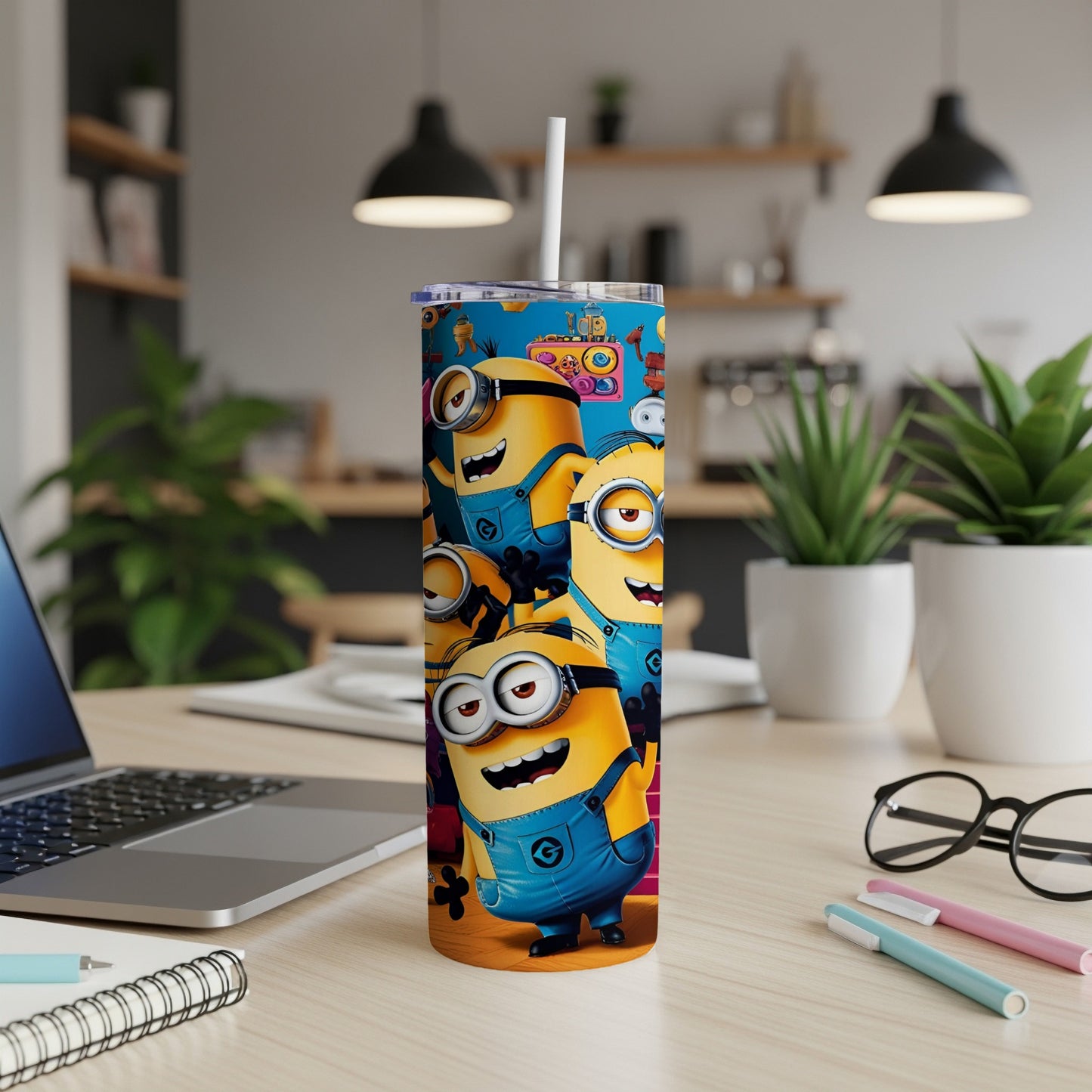 Minions characters on a blue tumbler with a straw, on a desk.