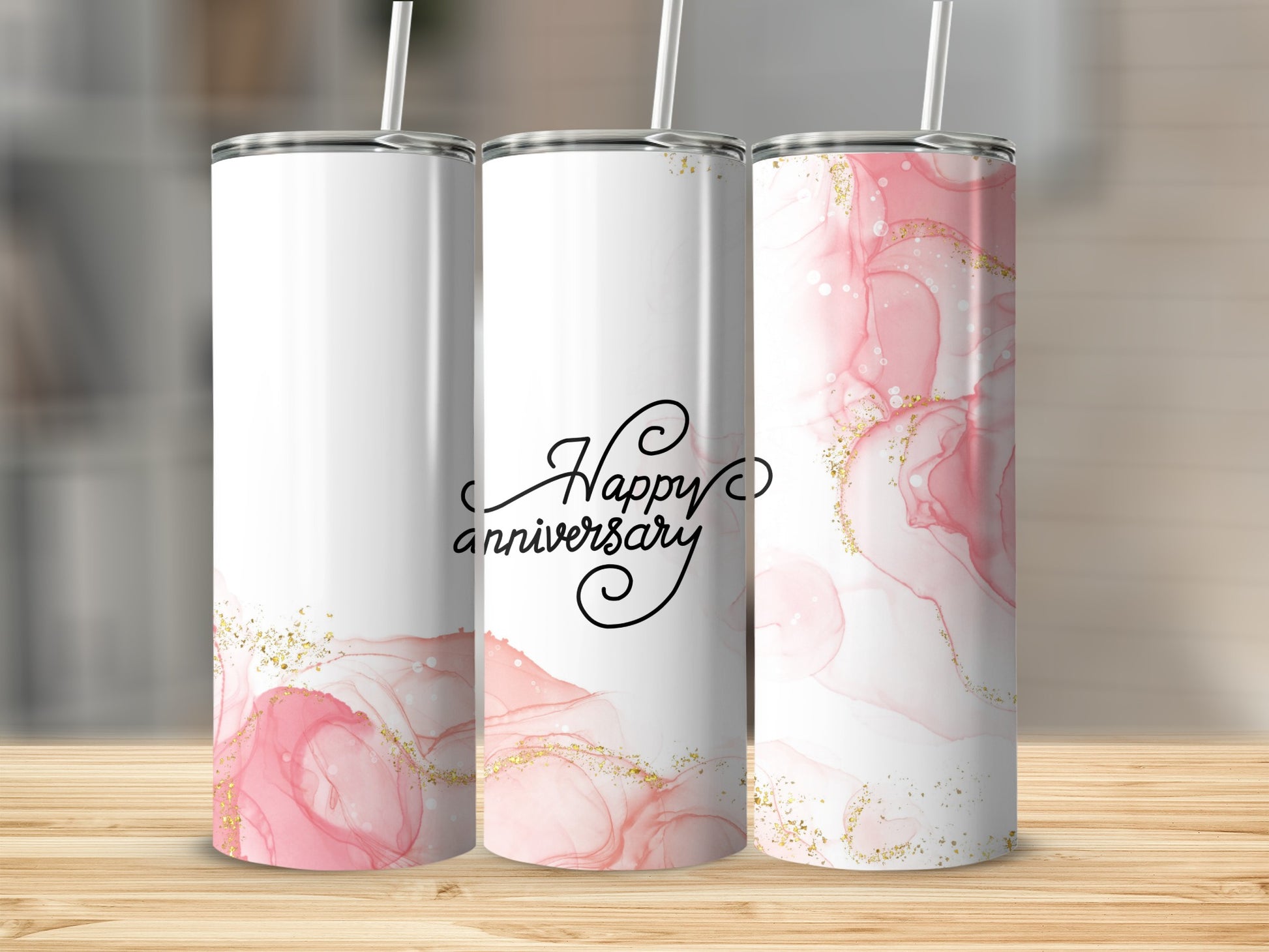Three tumblers with pink marble and gold glitter, one says "Happy Anniversary."