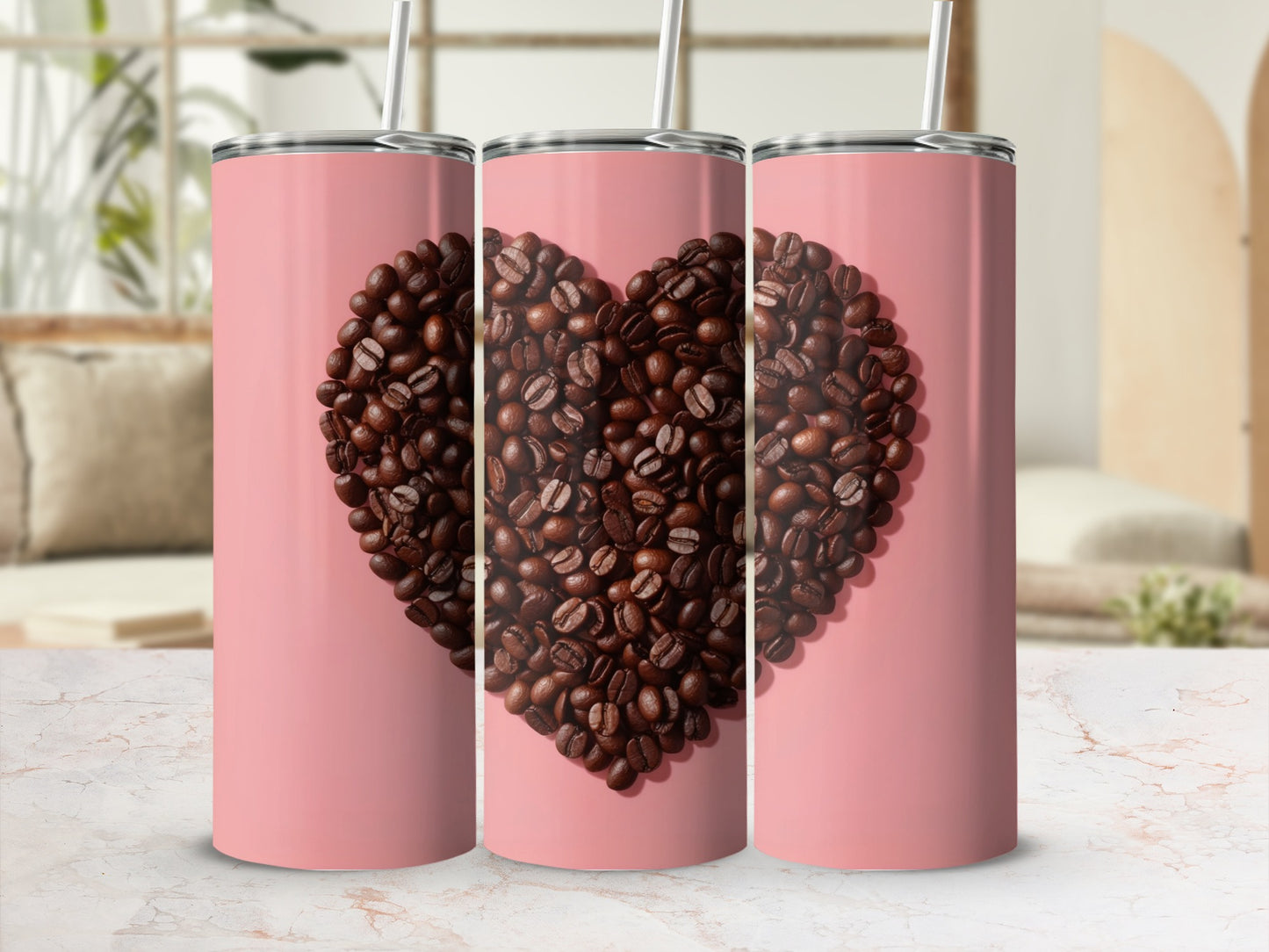 Three pink tumblers with a heart made of coffee beans on the front.