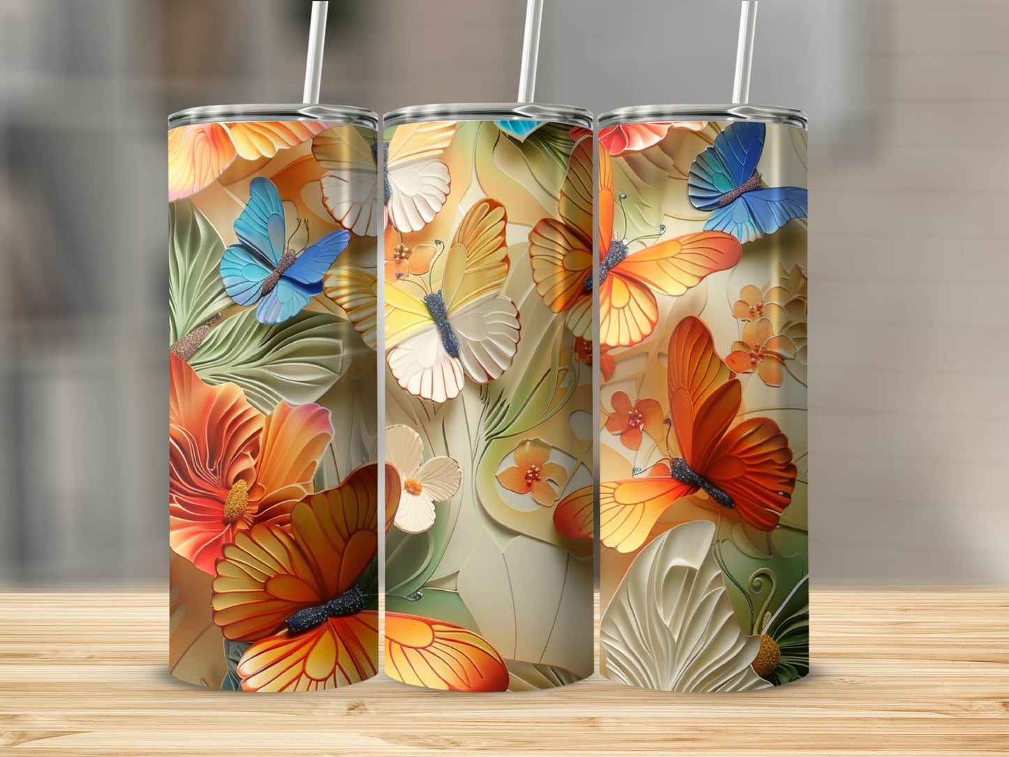 Three tumblers with colorful butterflies and floral designs.