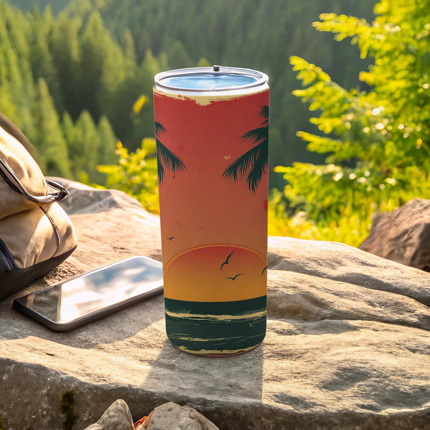 Tall tumbler with sunset, palm trees, and birds design on rocky surface.