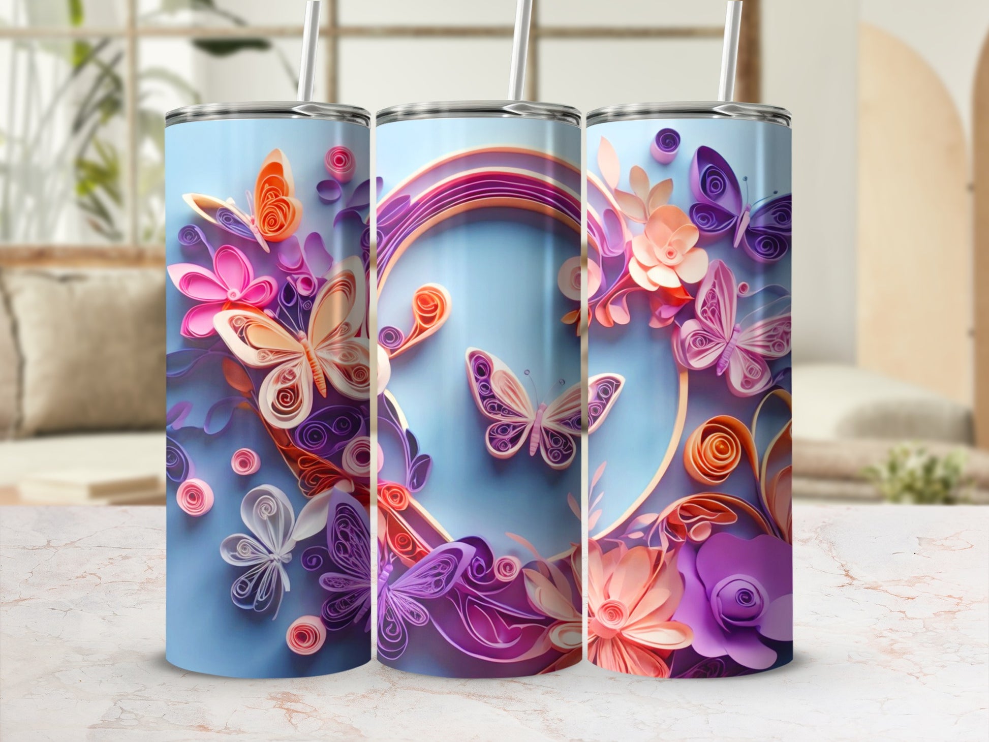 Three tumblers with a pastel blue background and quilled butterflies and flowers.