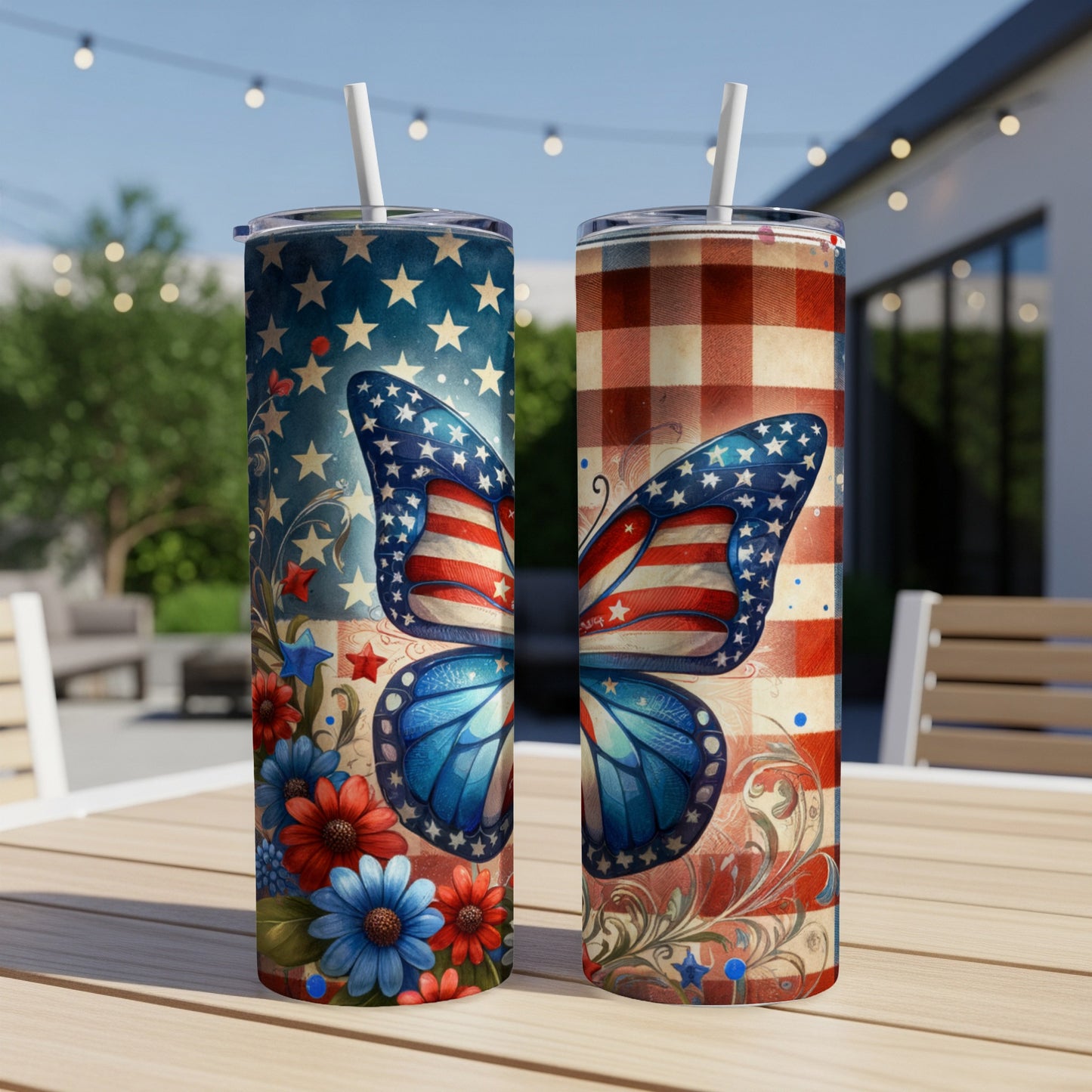 Two tumblers with patriotic butterfly designs on a table outdoors.