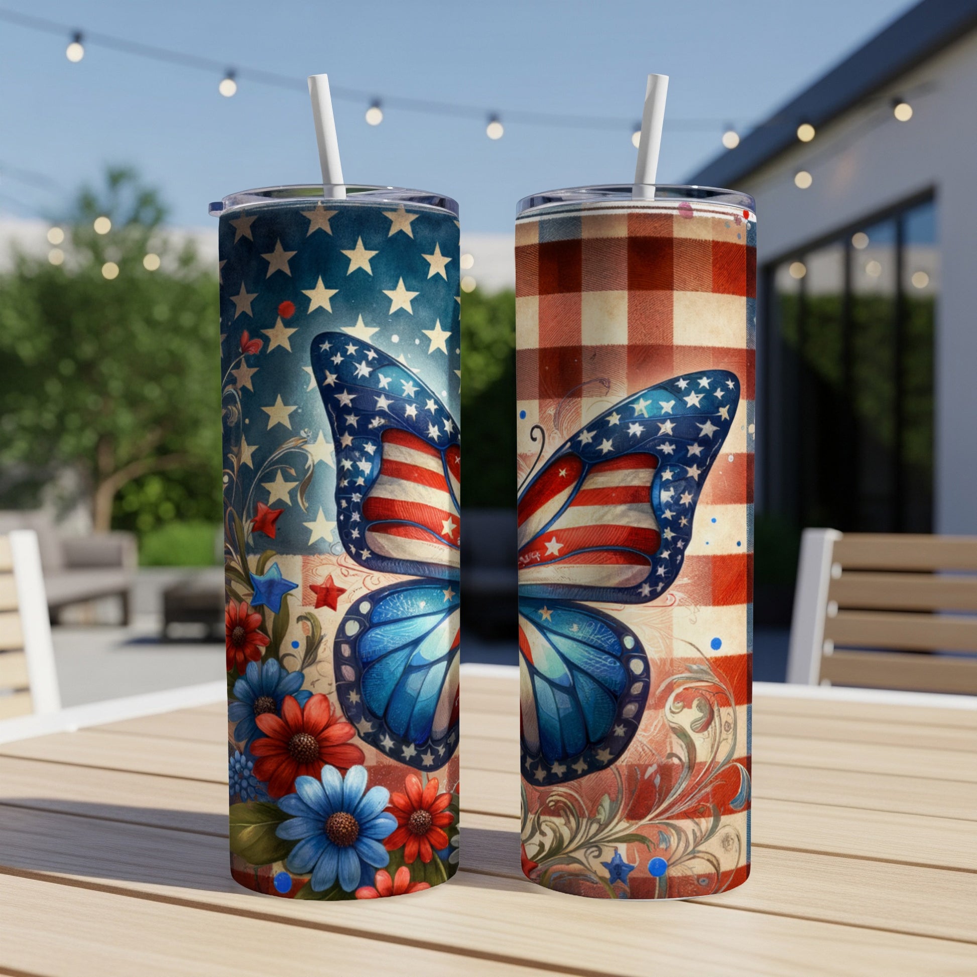 Two tumblers with patriotic butterfly designs on a table outdoors.