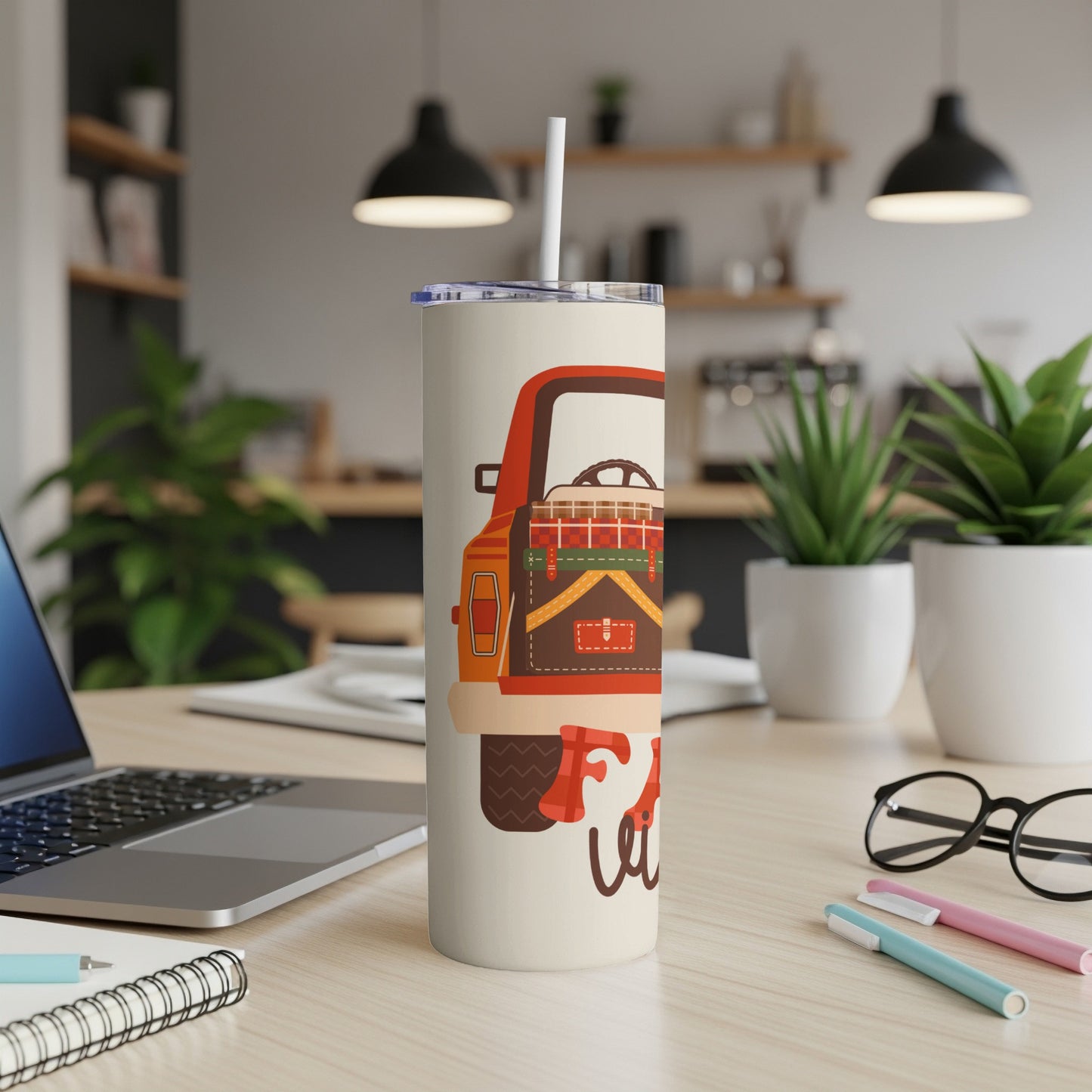 Tumbler with vintage red truck illustration, packed for a trip.